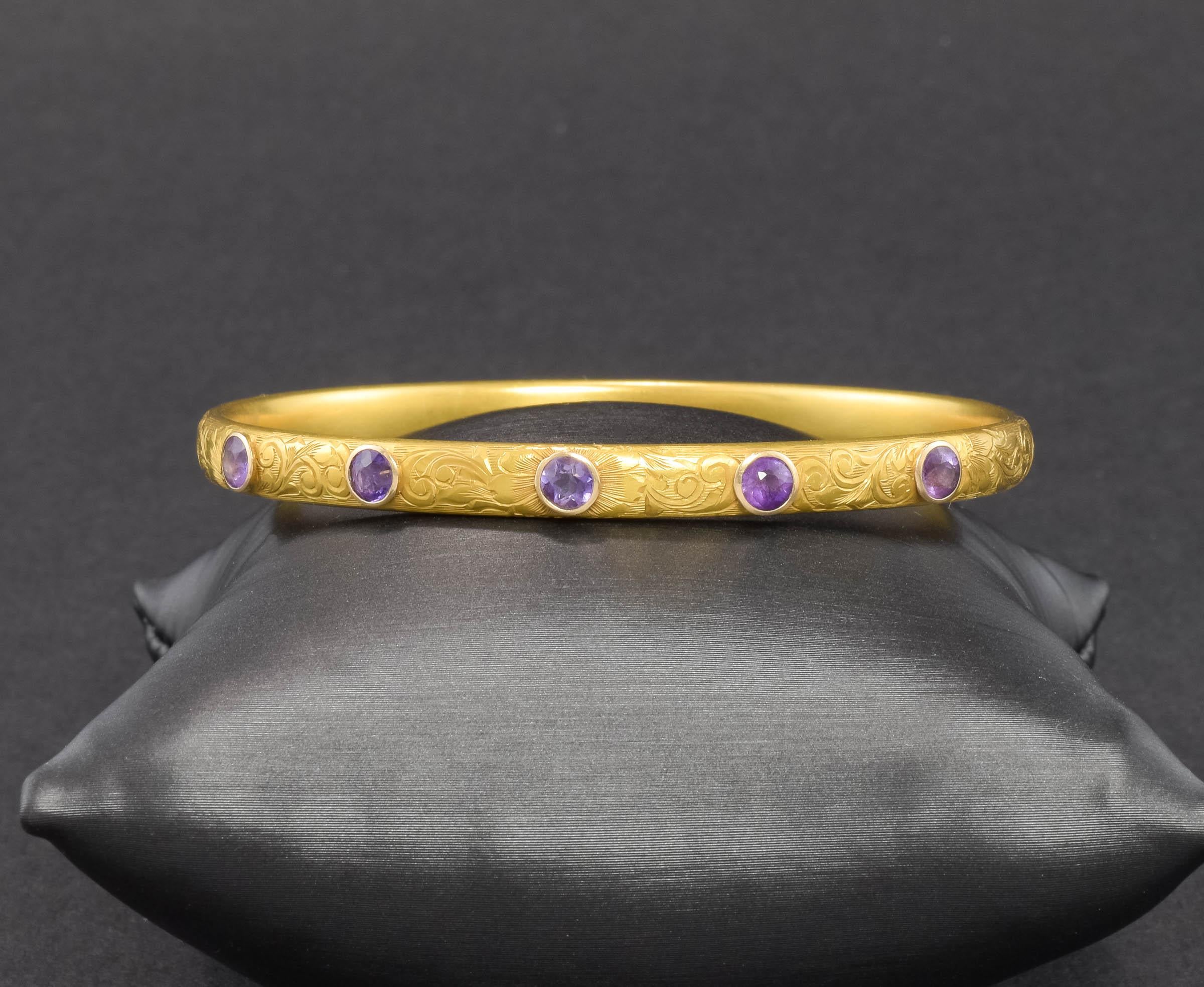 Art Nouveau period bangle bracelets by Krementz & Co are wonderful and this one is no exception.  Elegant and beautifully detailed, the splendid purple hue of the old cut amethysts is so luxurious against the rich color of the engraved gold.  It