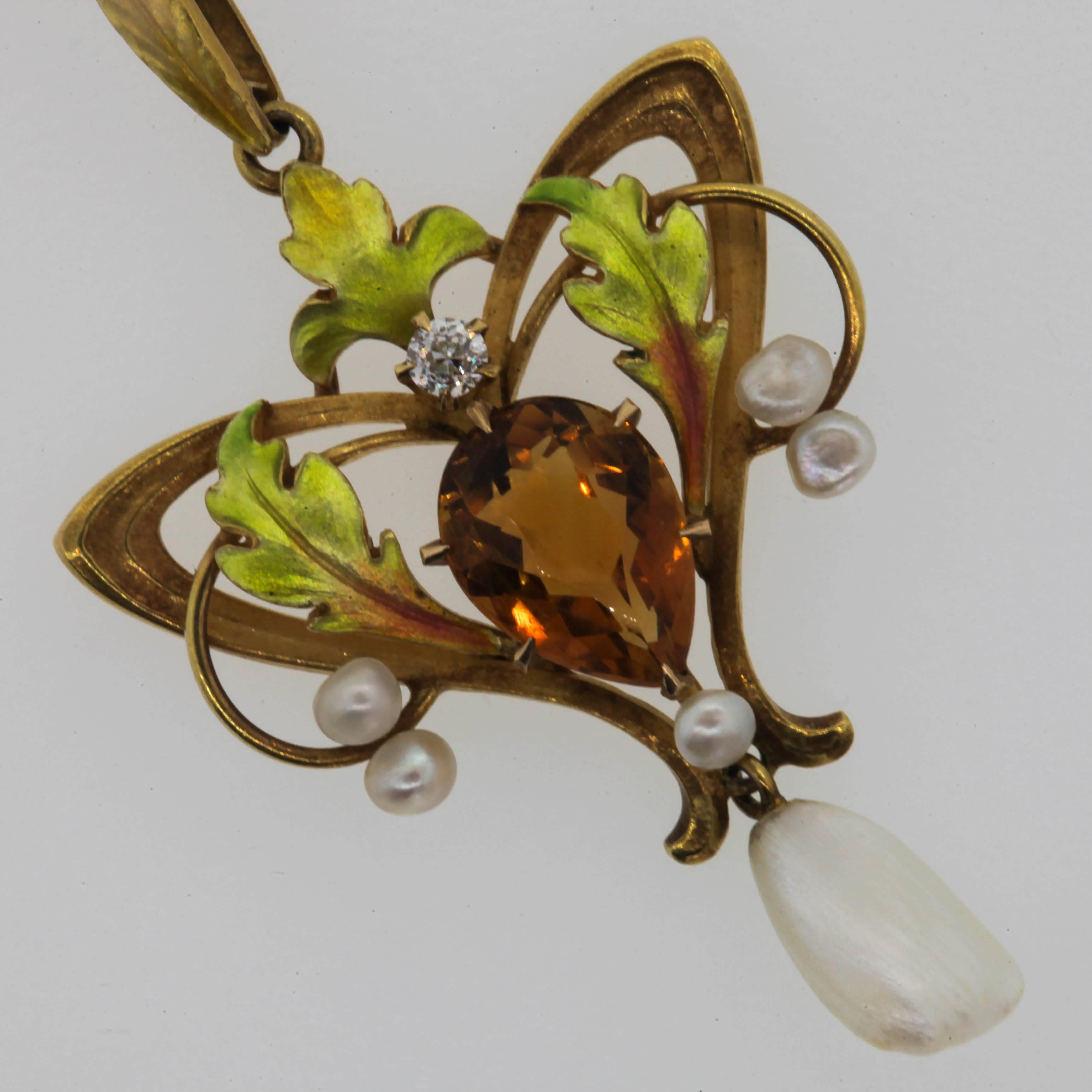 Time for Romance!  This docile turn of the 20th Century pendant shows off flowing intertwining triangular and swoop designs completed with variegated enamel leaves.  It nests a 1.15 carat a pear shape orange Citrine, dangles a natural fresh water