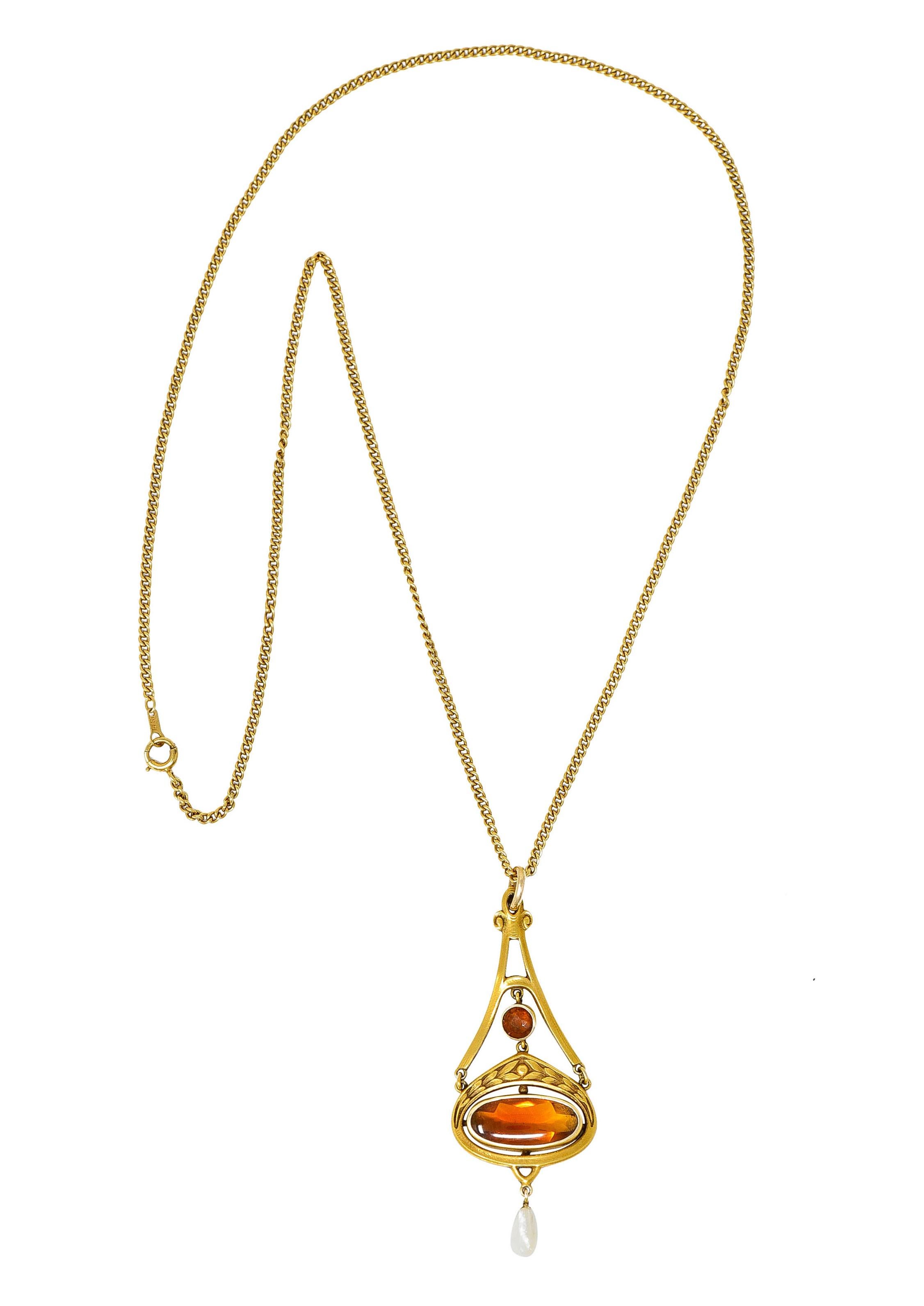Pendant articulates and is designed as a pitched form over a chestnut shaped base

Decorated with scrolled volutes and a highly rendered wheat motif and terminates as a dogtooth pearl drop

Centering a 4.5 mm round cut citrine and an elongated oval