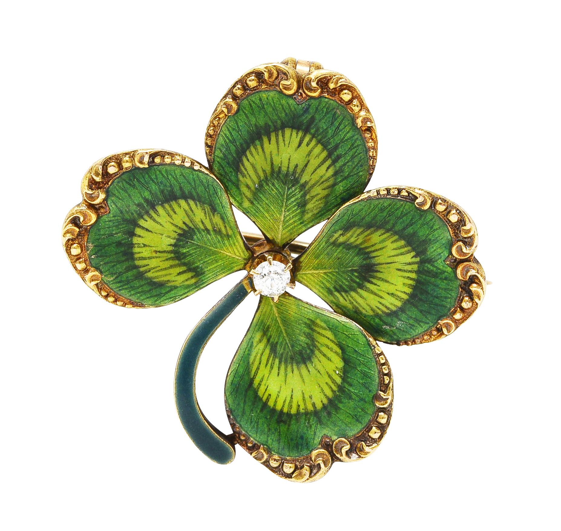 Designed as a highly rendered four leaf clover featuring grooved scroll motif edges and basse-taille enamel. Transparent matte dark green with linear vein-like engraving and opaque light green mid-section. With opaque blueish-green enamel stem -