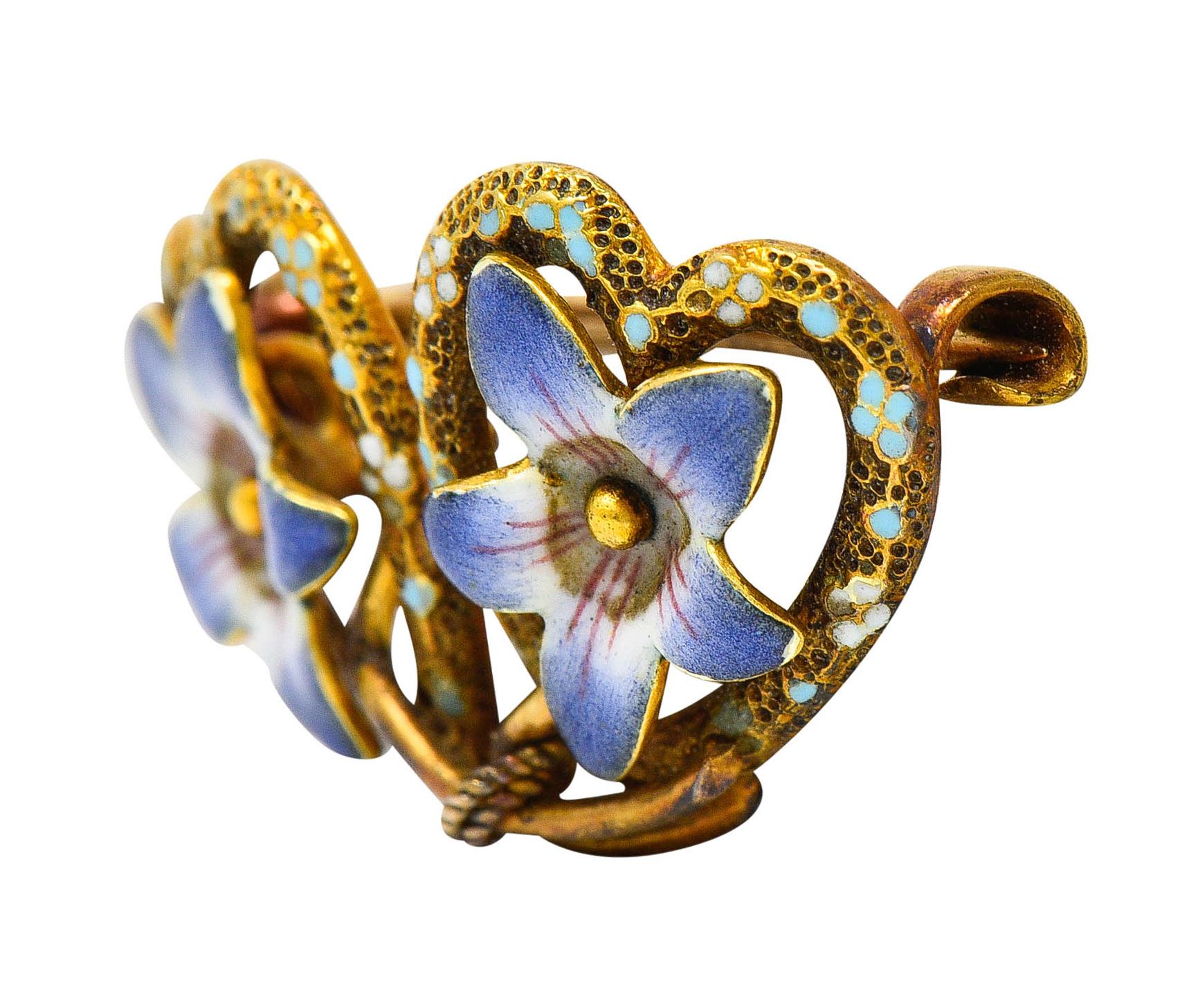 Petite brooch is designed as two hearts with bloomed and intertwined flowers

Flowers are glossed with bright lavender enamel - exhibiting no loss

Hearts are texturous with pastel enamel accents throughout

Completed by a pin stem with