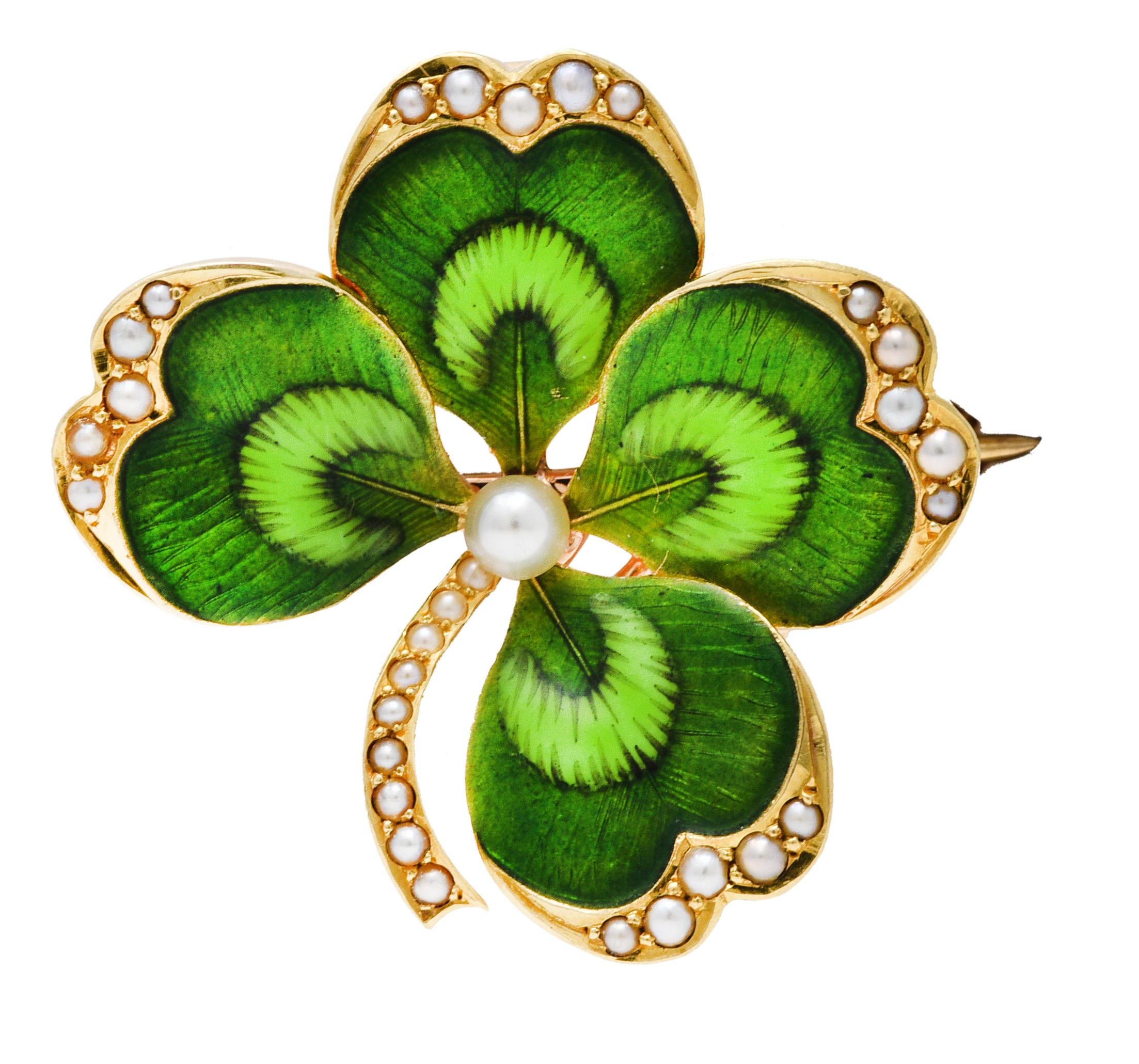 Pendant brooch is designed as a four leaf clover with painted matte guilloche enamel leaves

Transparent deep green with engraved linear pattern with opaque light green accents

Centering a 3.0 mm round pearl - white in body color with mild