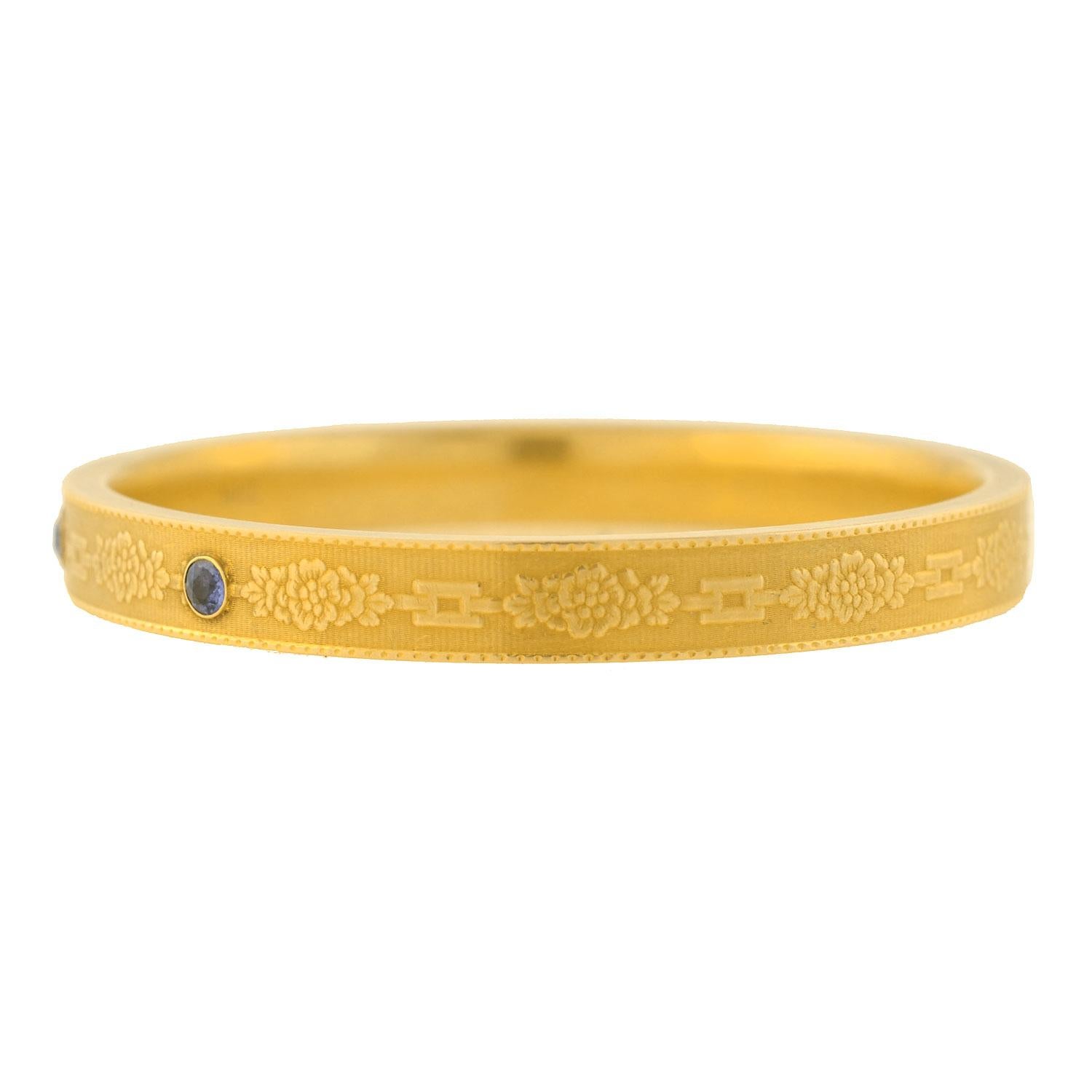 A beautiful signed Krementz bracelet from the late Art Nouveau (ca1915) era! Crafted in 14kt yellow gold, this stunning piece features a unusual and gorgeous textured design showcasing three beautiful sapphire stones. Encircling the entire surface