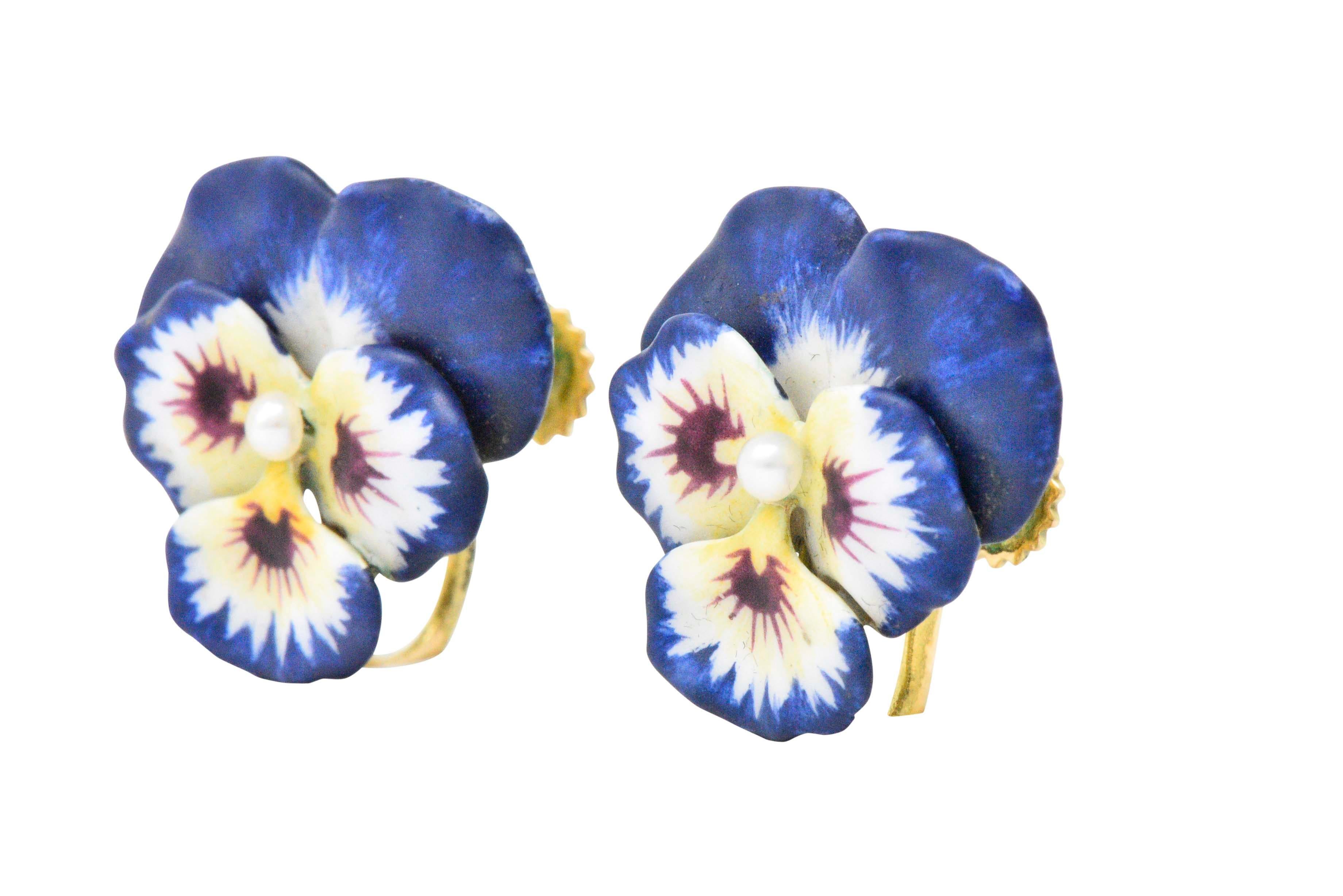 Designed as pansies with indigo, white, yellow and wine colored enamel and centering a seed pearl

The has a matte finish and is in very good condition with no signs of loss

Sweet beautiful and colorful earrings

With screw backs

Maker's mark for