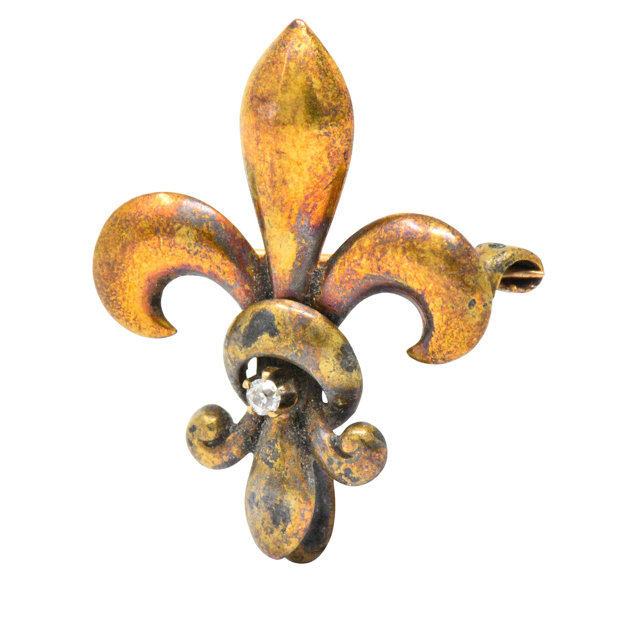 Centering an old European cut diamond weighing approximately 0.02 carats, eye-clean and white

Designed as a polished gold fleur-de-lis

Tested as 14k gold

Maker's mark for Kremetz and loop to suspend a drop

Measures: Approx. 1 x 3/4 Inch

Total
