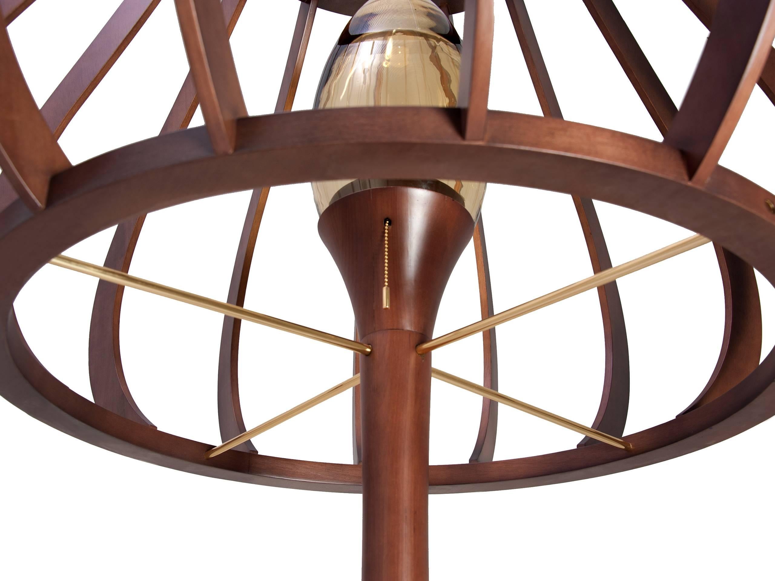 This is a proposition of lamp with wood turned base and lamp shade also made of wood.