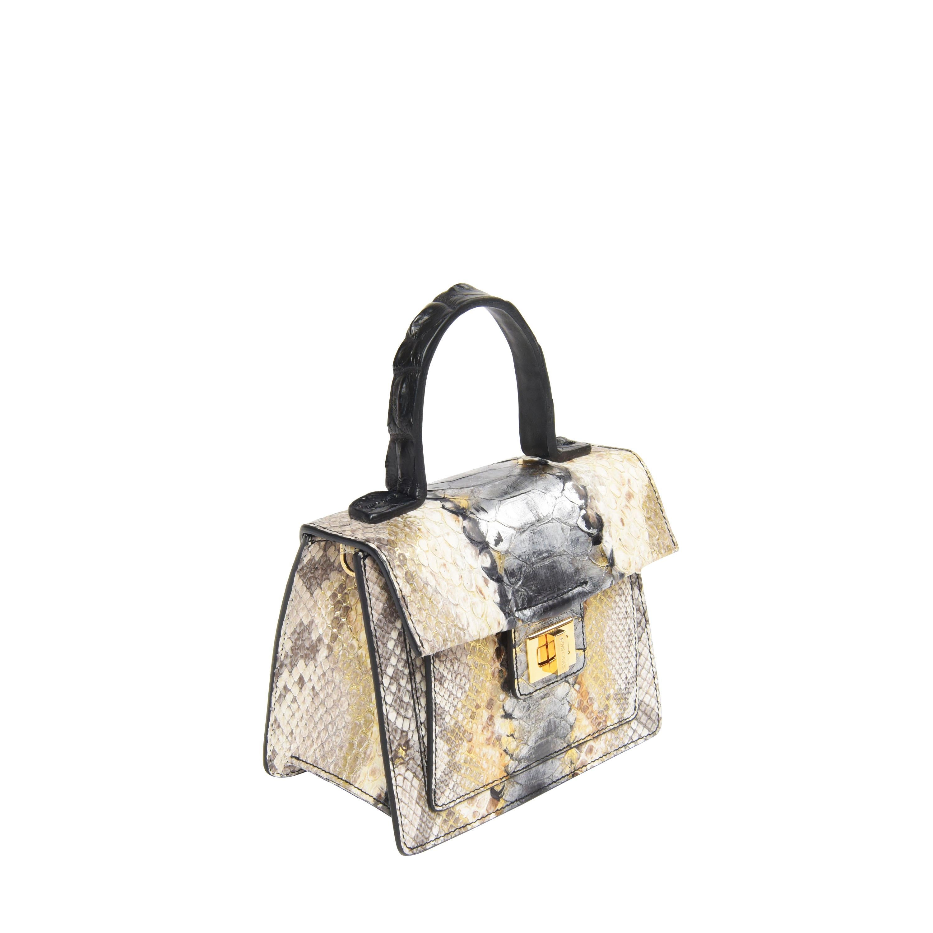 Mini Kandie bag in matte python and alligator handle with adjustable strap, comes with frontal storage space and inner pocket. The bag is completed with KRENOIR's signature enameled lock

Measures 7