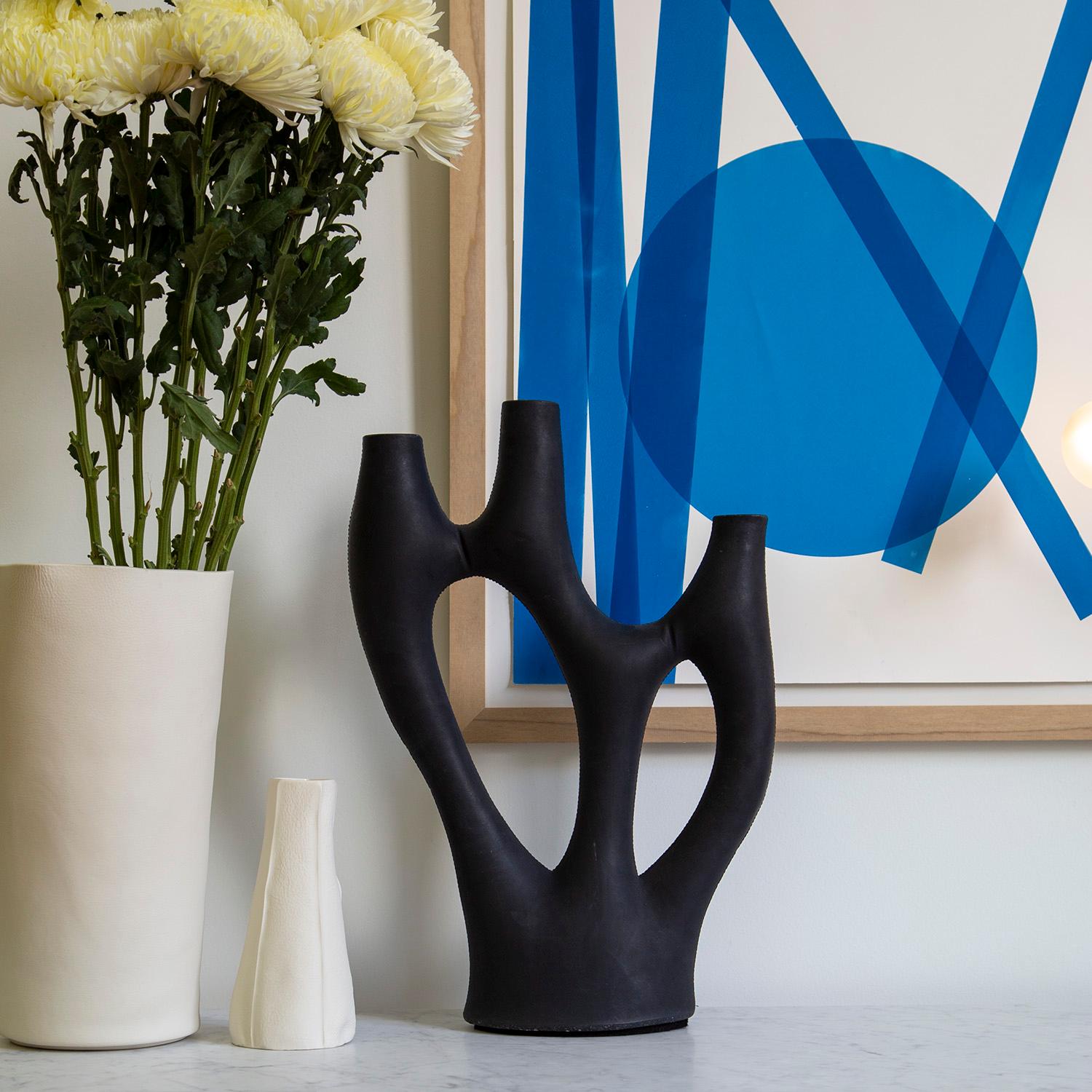 Bold and distinctive, the Kreten candelabra captures the liquidity of concrete in its fluid branching form. Designed with three holes atop each branch for candlesticks, the Kreten candelabra can be an eye-catching source of illumination or can stand