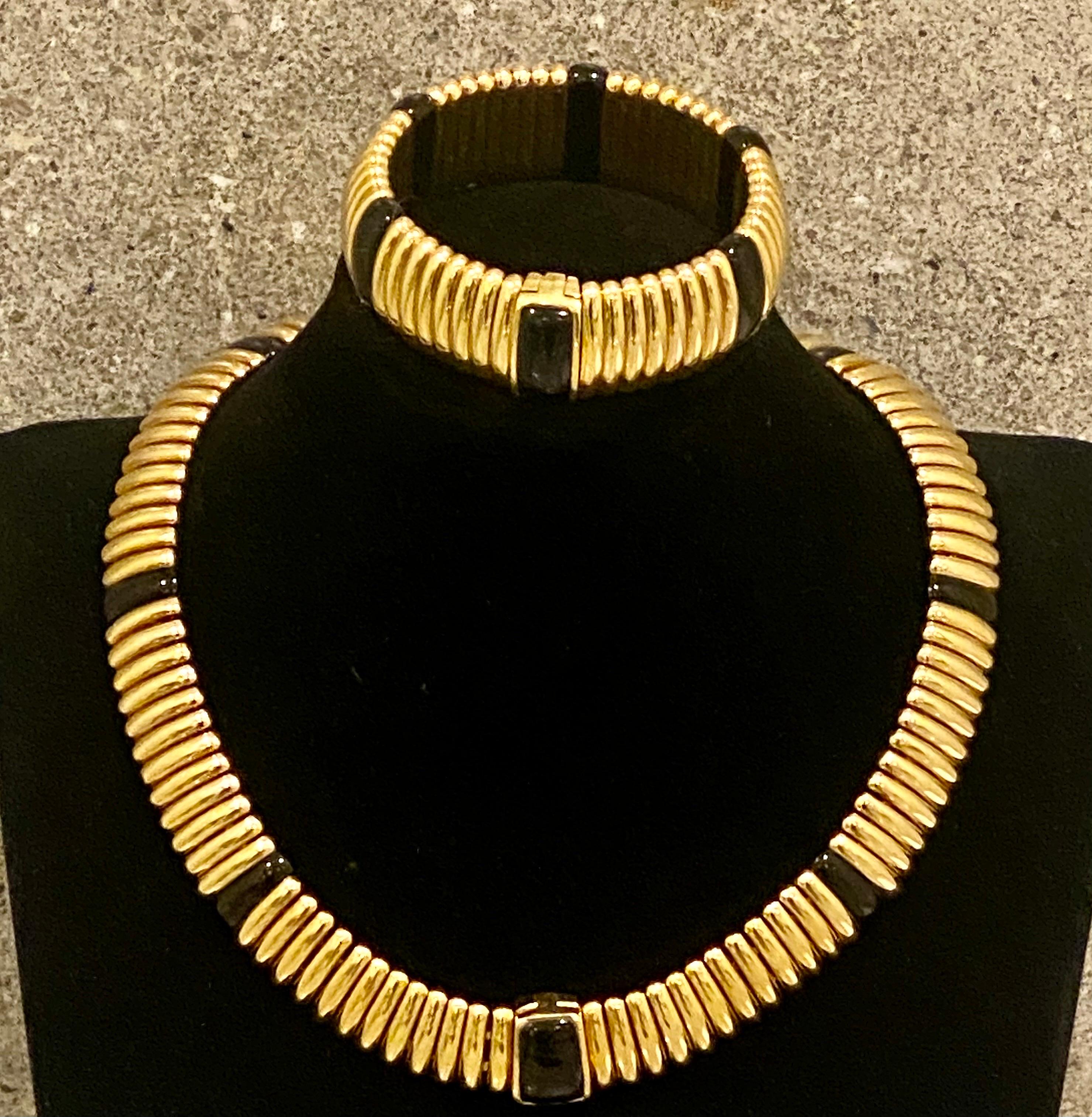Kria Gioielli Italian 18K yellow gold and onyx Necklace and bracelet Suite showcasing a ribbed geometric design accented with onyx plaques with hidden clasps with a very secure closure. Signed 'Kria 750.
Measurements: The necklace measures 18 inches