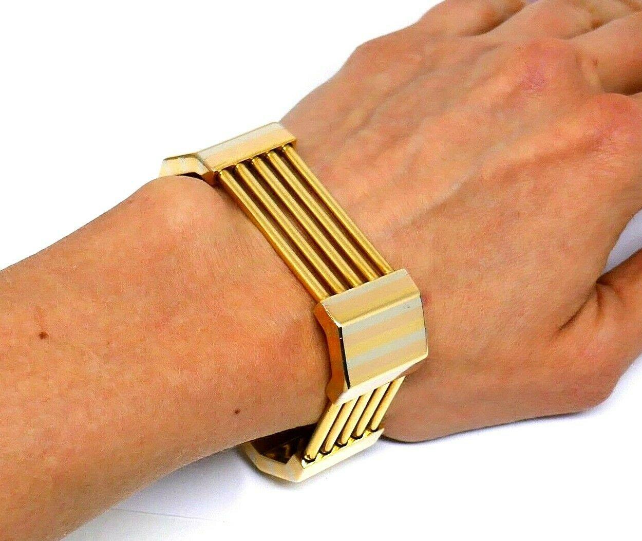 An unusual shape and tri-tone golden stripes on the sides make this bracelet a truly unique piece you'll be wearing every day.
Featuring 18k rose, white and yellow gold inlay that works perfectly well with the yellow gold bars. This bracelet is made