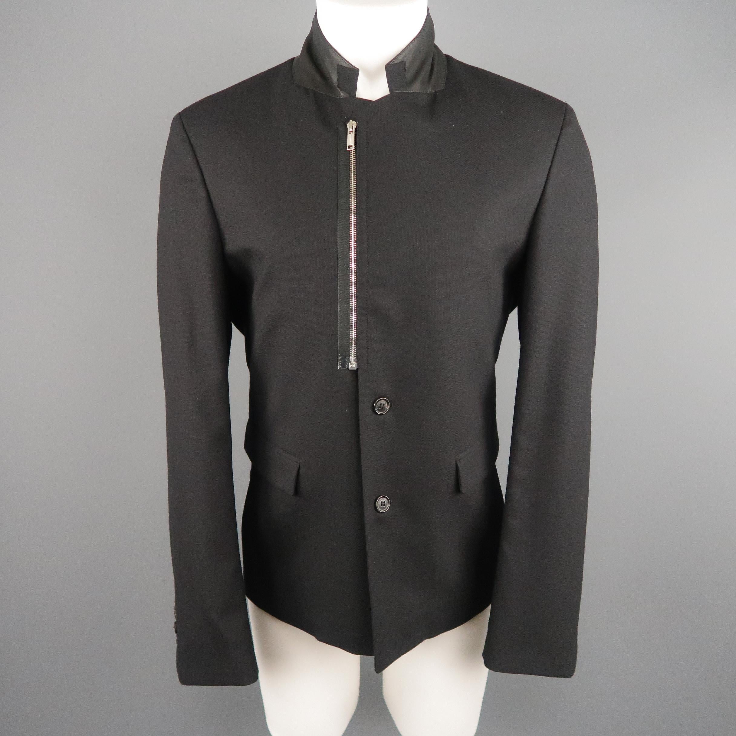 KRIS VAN ASSCHE  Sport Coat comes in a black tone in a solid wool blend material, with a leather lining at collar, notch lapel, flap pockets, zip and 2 buttons at closure, single breasted, and with a buttoned cuff. Made in Italy.
 
Excellent
