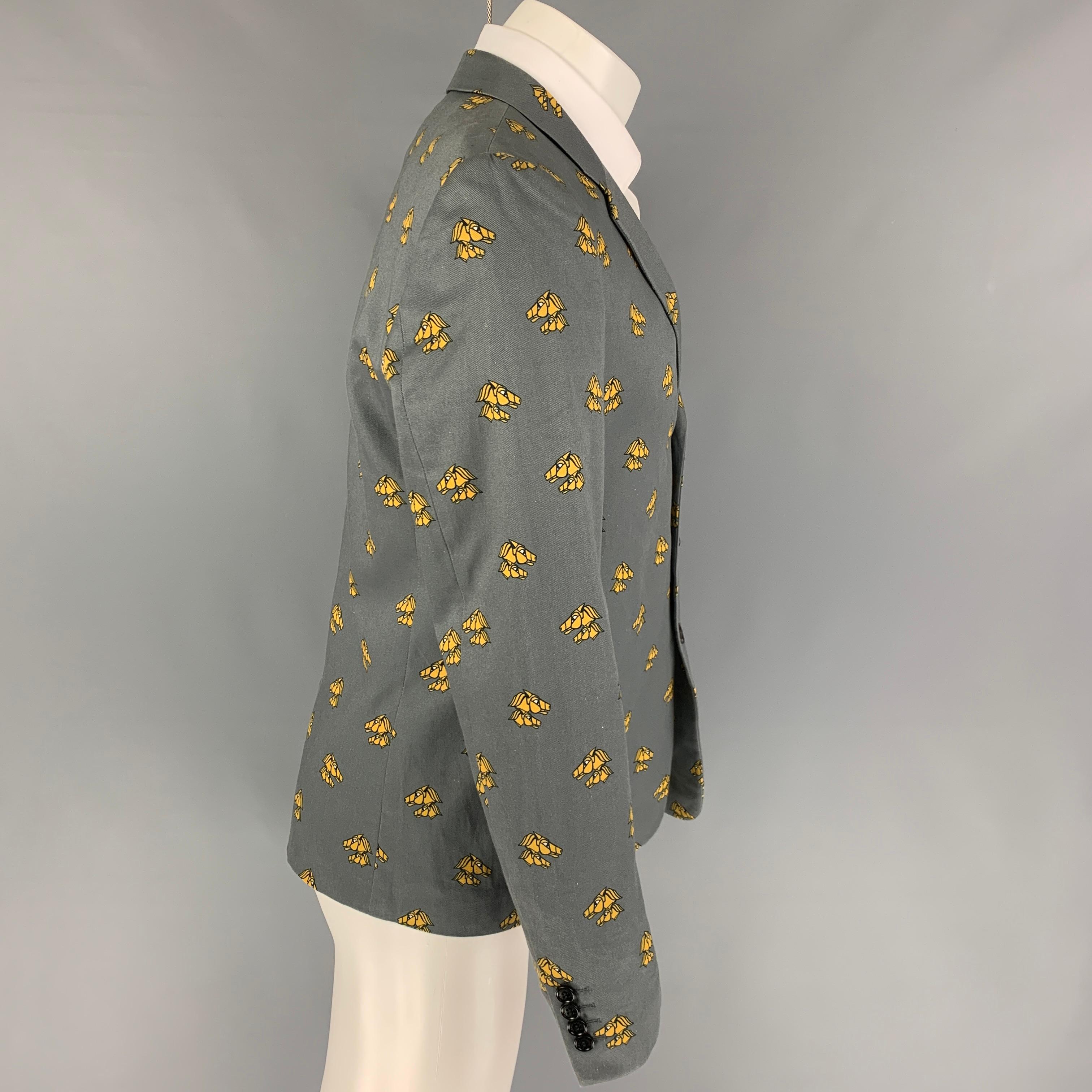 KRIS VAN ASSCHE sport coat comes in a grey & mustard print polyester with a full liner featuring a notch lapel, slit pockets, single back vent, and a three button closure. 

Very Good Pre-Owned Condition.
Marked: 50

Measurements:

Shoulder: 17.5