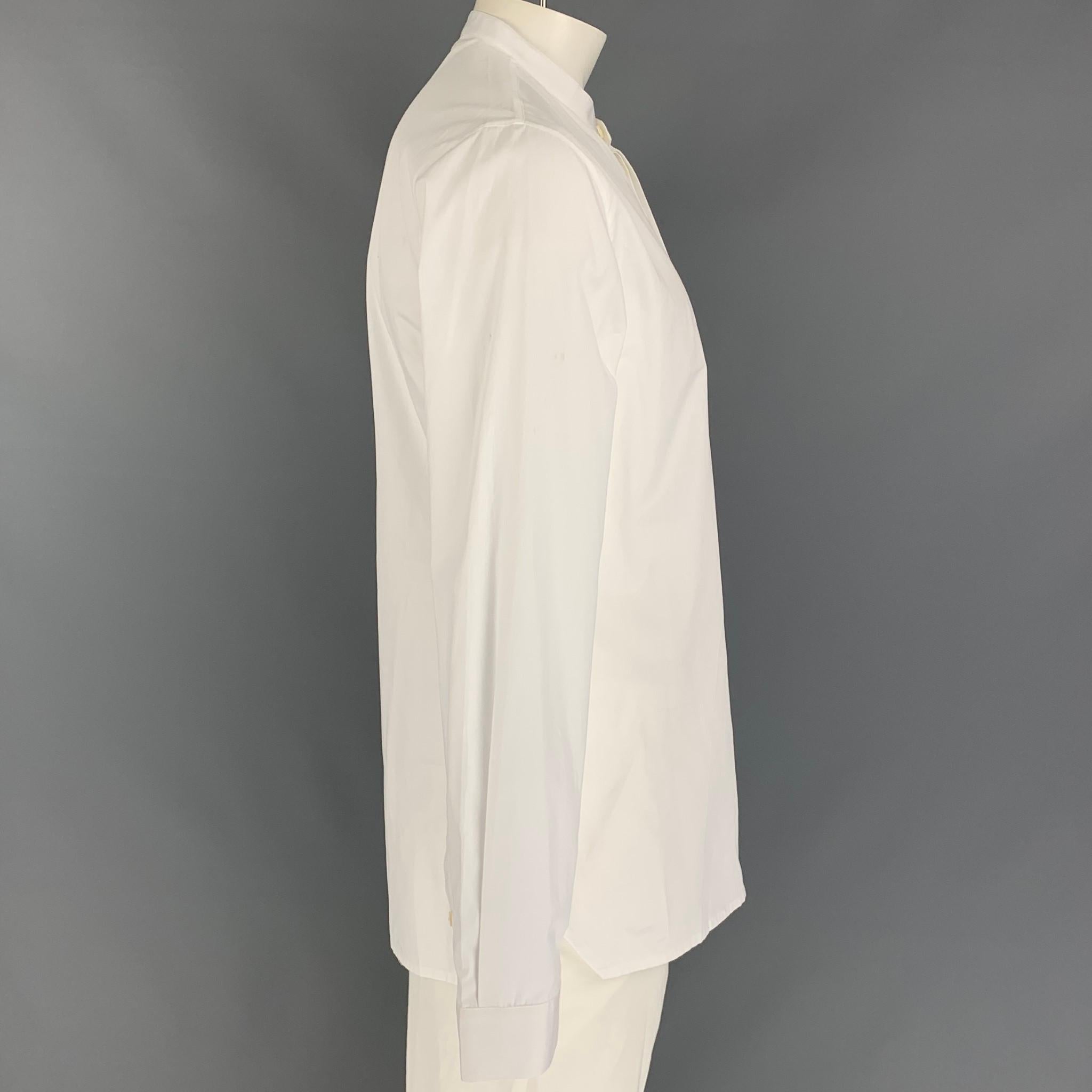 KRIS VAN ASSCHE long sleeve shirt comes in a white cotton featuring a nehru collar and a buttoned closure. Made in Italy. 

Very Good Pre-Owned Condition.
Marked: 52

Measurements:

Shoulder: 18.5 in.
Chest: 44 in.
Sleeve: 28 in.
Length: 32 in. 