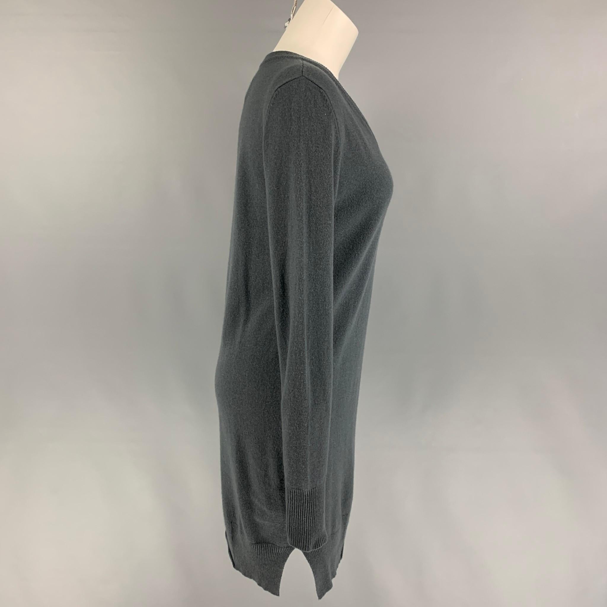 KRISTENSEN DU NORD sweater dress comes in a grey wool blend featuring long sleeves, small side slits, and a v-neck. Made in Italy. 

Very Good Pre-Owned Condition.
Marked: 1

Measurements:

Shoulder: 15.5 in.
Bust: 34 in.
Sleeve: 28 in.
Length: 34