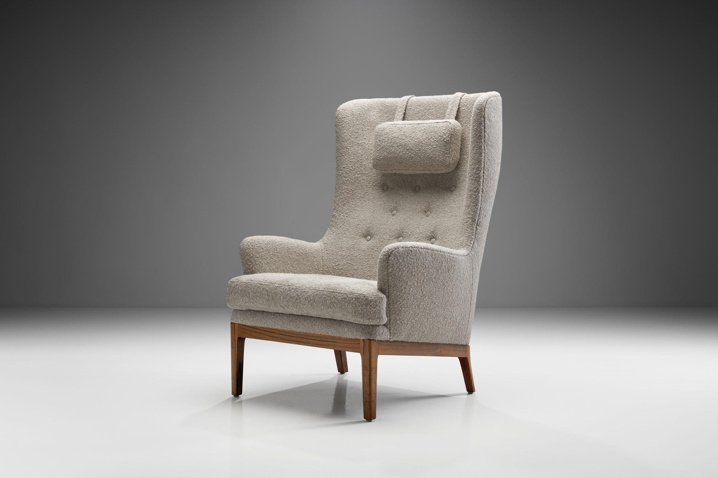 This “Krister” is among Swedish design icon, Arne Norell’s coziest works. This high-back armchair’s comfort is equaled by its stylishness and elegance.

The chair is raised on a teak wooden frame covered by beautiful, light colored bouclé