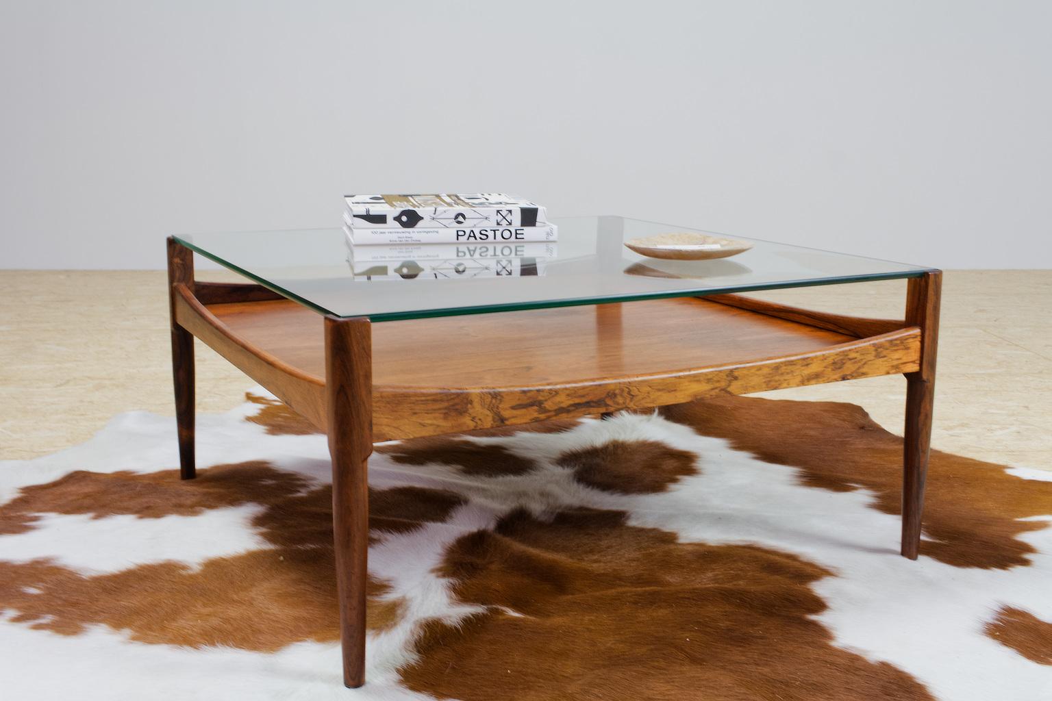 A great example of Scandinavian elegance. This rosewood and glass coffee table by Danish designer Kristian Vedel is a great blend of style, functionality and playful form. The listed item is made of solid rosewood and 8mm / 0.31inch glass with
