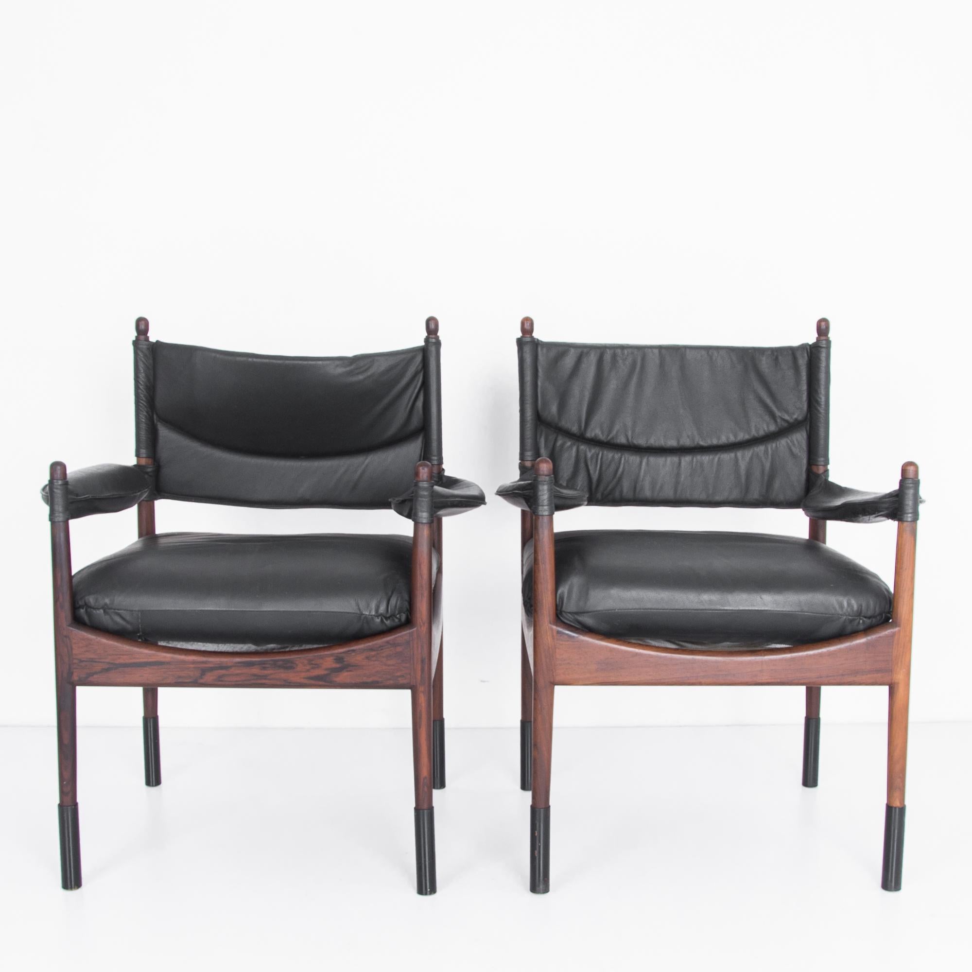 A pair of rosewood and leather chairs designed by Kristian Vedel in the 1960s. These chairs showcase the combination of innovation, comfort and respect for materials for which the Scandinavian Modernist designer was known. Softly polished rosewood