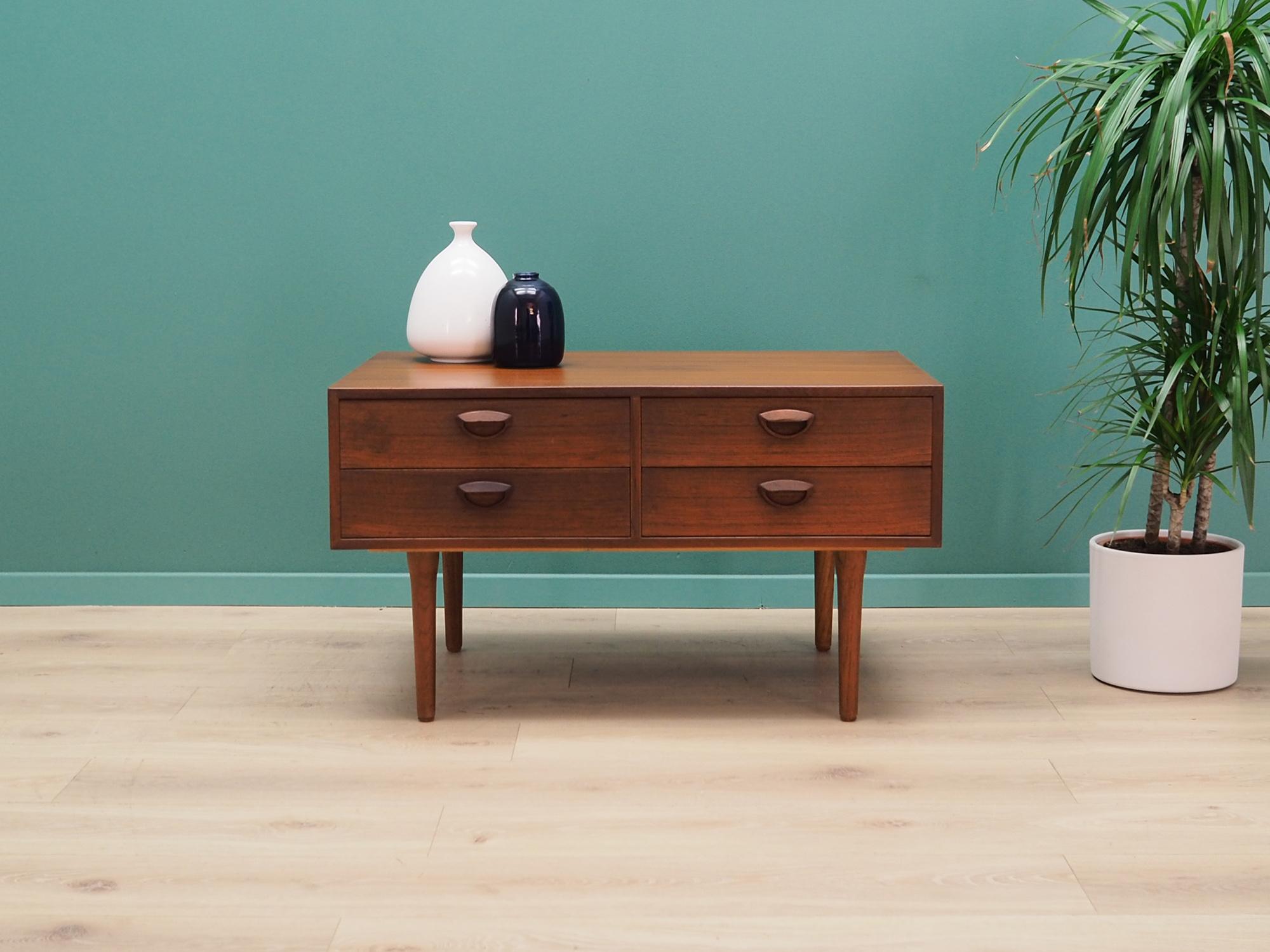 Fantastic chest of drawers from the 1960s-1970s. Scandinavian design, Minimalist form. The furniture is covered with teak veneer, legs are made of solid teak wood. Designed by Kai Kristiansen. The chest of drawers has four stylish drawers arranged