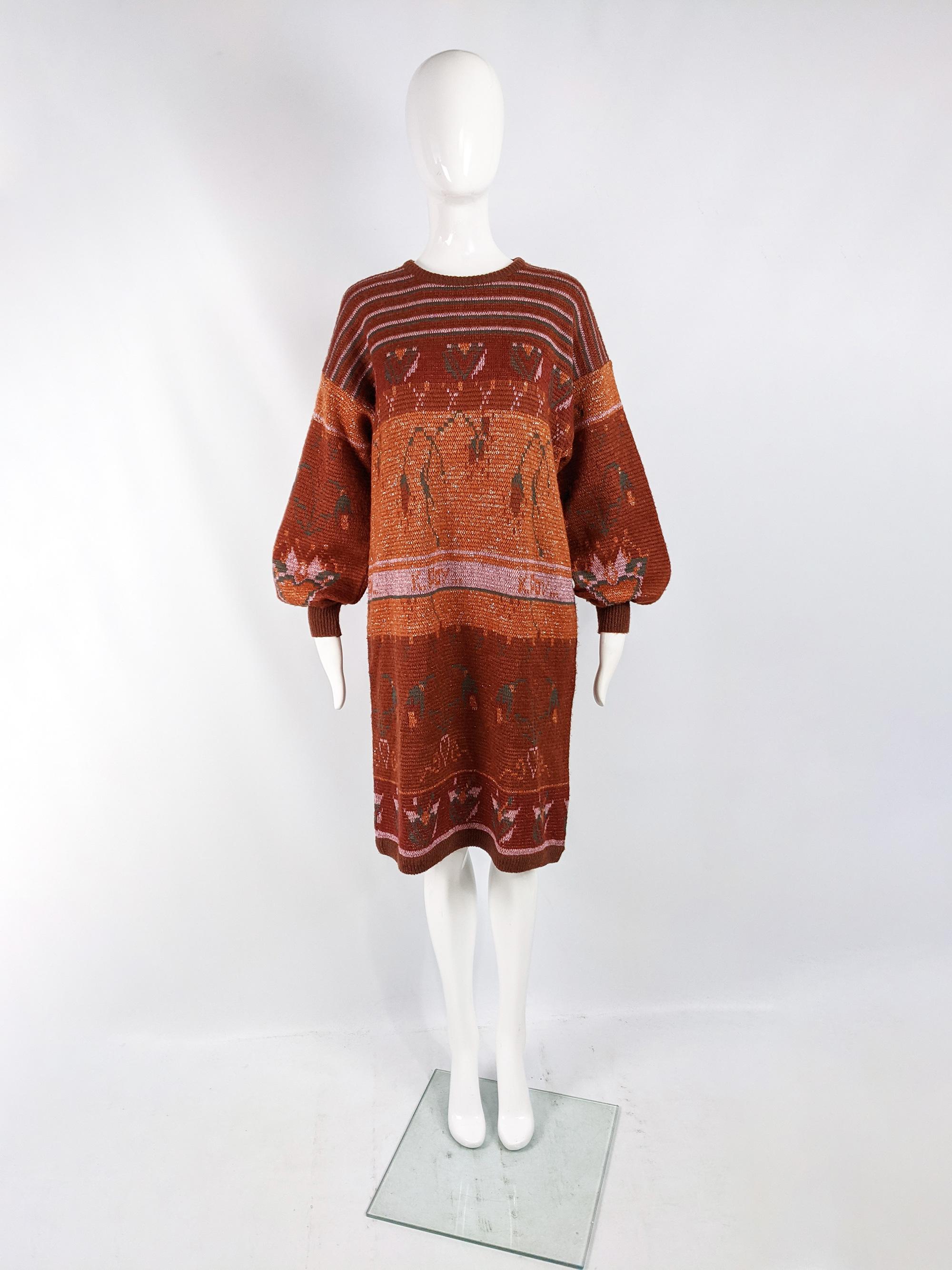A fabulous vintage womens sweaterdress from the 80s by luxury Italian fashion house, Krizia. In an orange acrylic, wool and kid mohair knit fabric with a lurex thread running throughout. With huge balloon sleeves and a loose, comfy fit that would