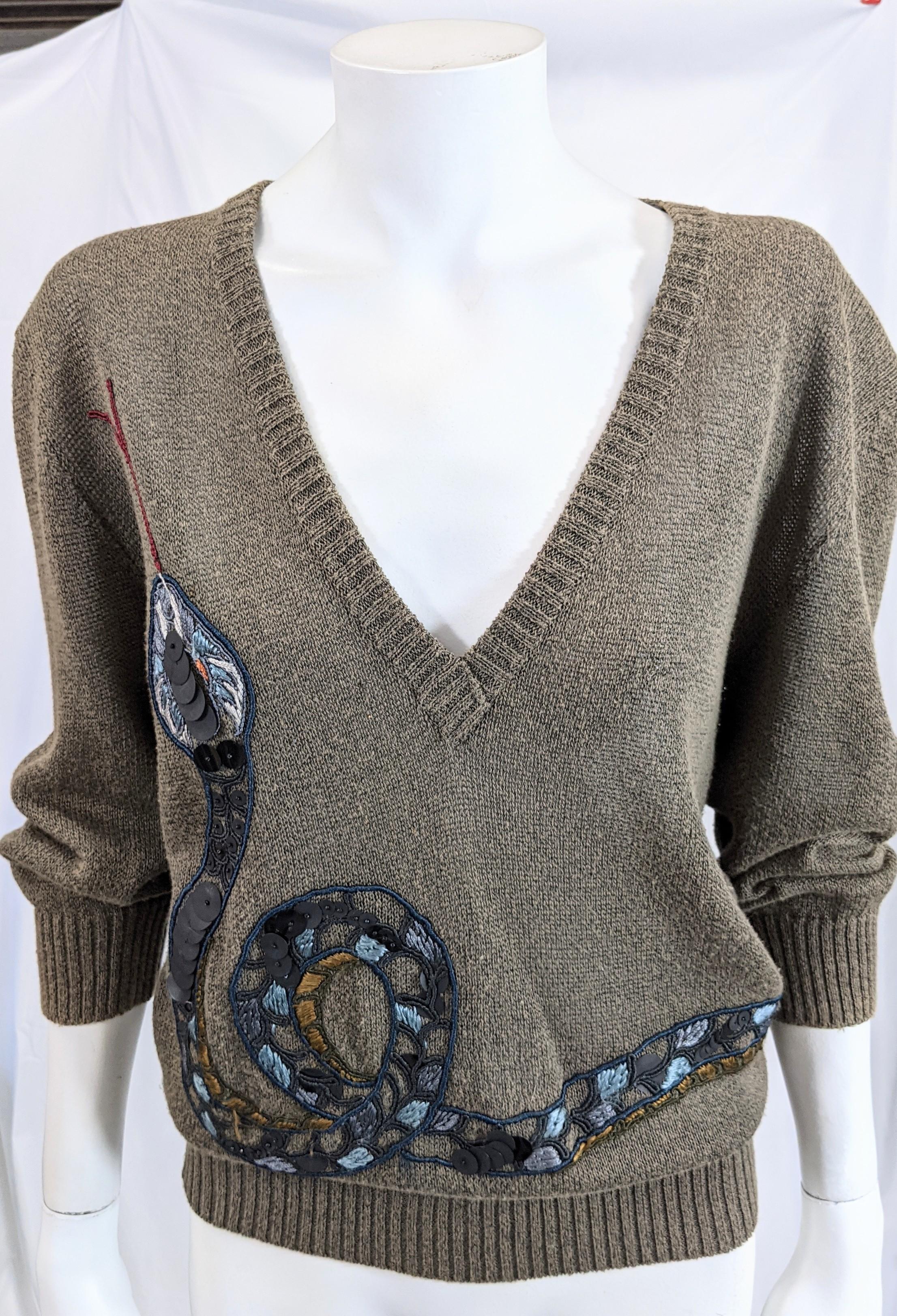 Fun Krizia Serpent knit sweater of a stone grey cotton knit with a deep front V neckline. Embellished with an embroidered coiled serpent with paillette sequin accents. 
Vintage size 44, Modern size is smaller. 
Excellent Condition, 50% Cotton,50%