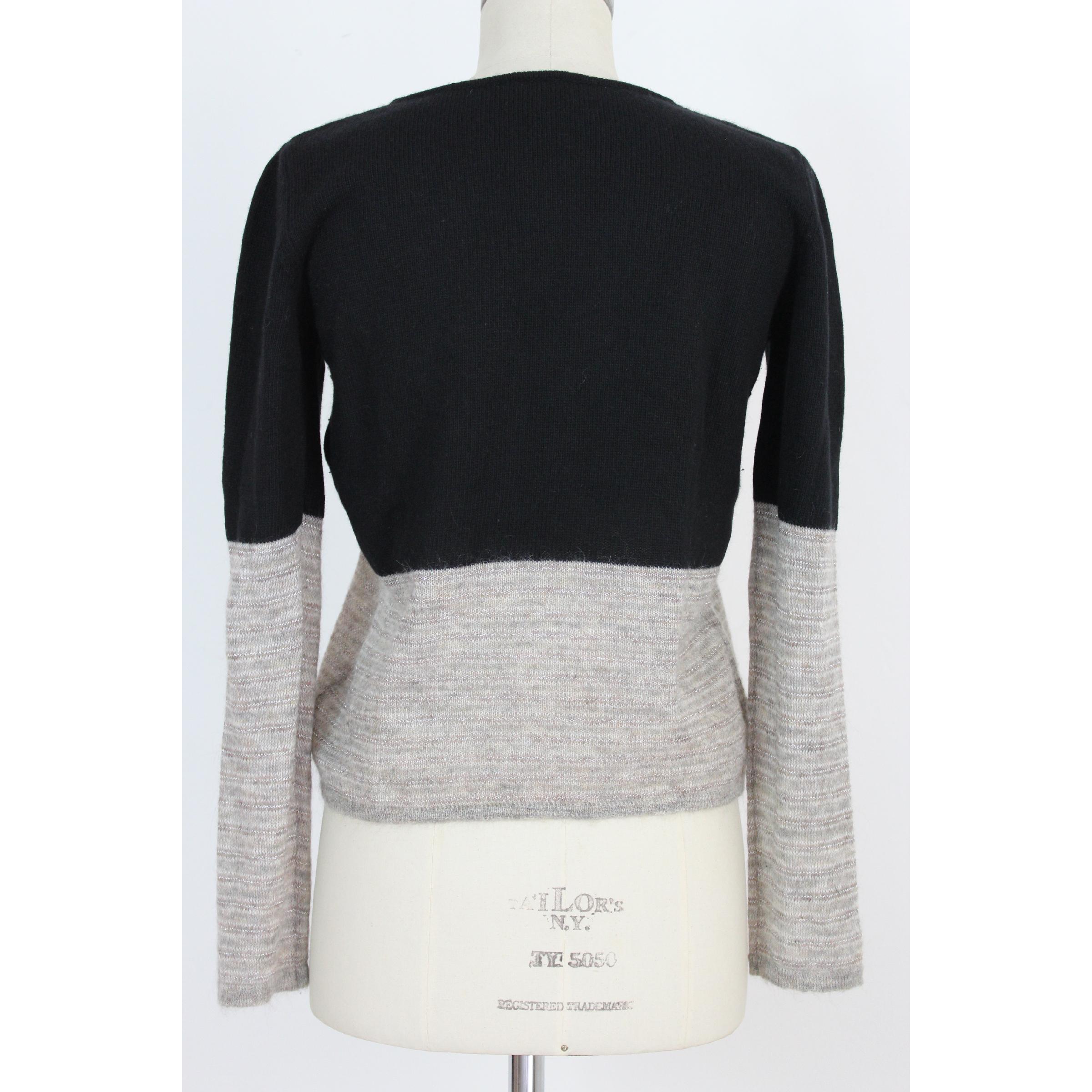 Krizia e Poi woman vintage 80s sweater. Black and gray color with laminated threads, crew neck, 28% wool 18% viscose 12% cashmere 24% polyamide 15% mohair 3% cupro. Made in Italy. Excellent vintage condition. 

Size: 44 It 10 Us 12 uk 

Shoulder: 44