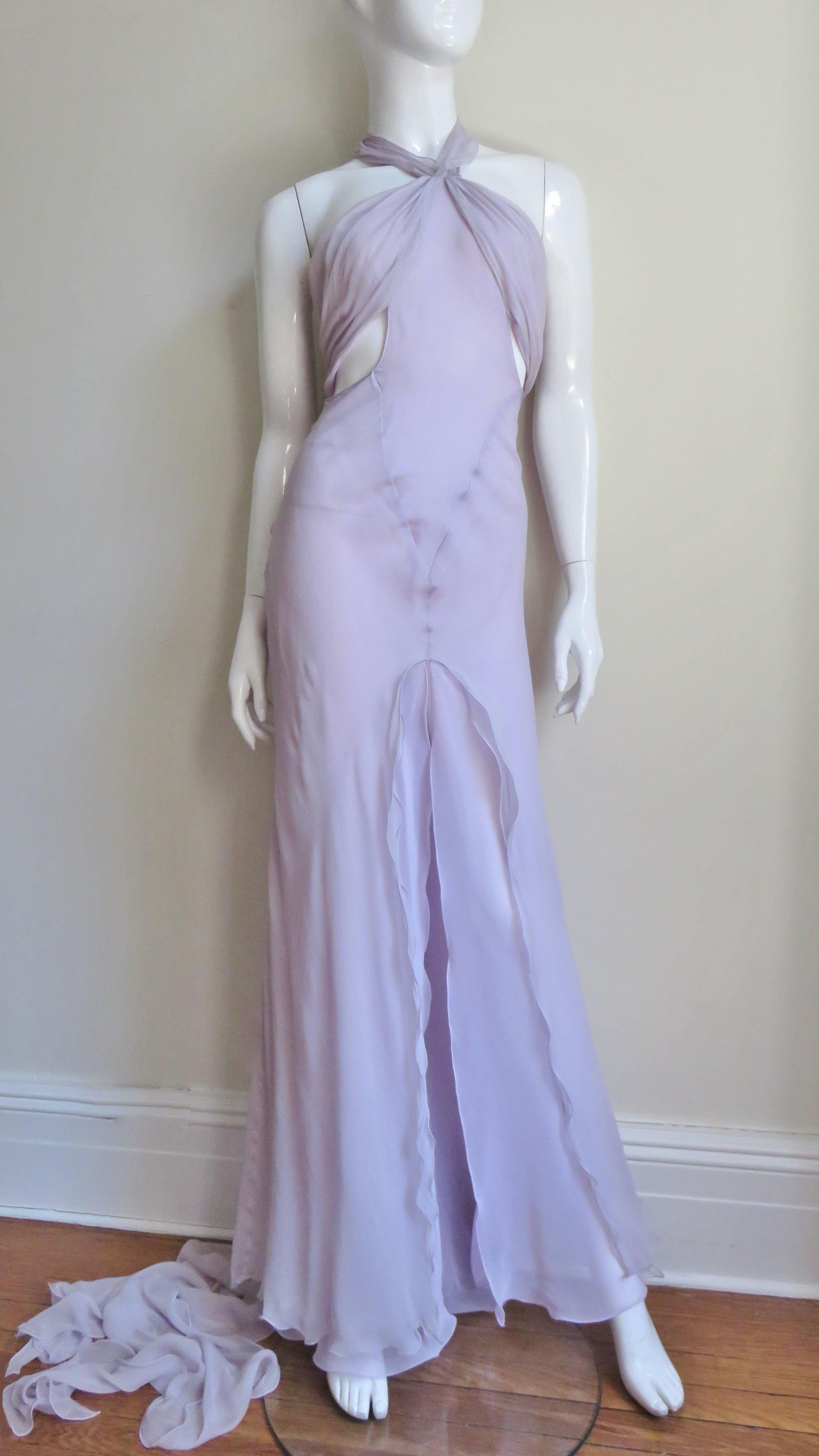 A gorgeous ethereal gown from Krizia made of layers of semi sheer lavender silk.  A floating dream on the runway it has spaghetti straps with a ruched panel across the bust and 2 draping panels exposing the side waist.  Layers of silk form the skirt