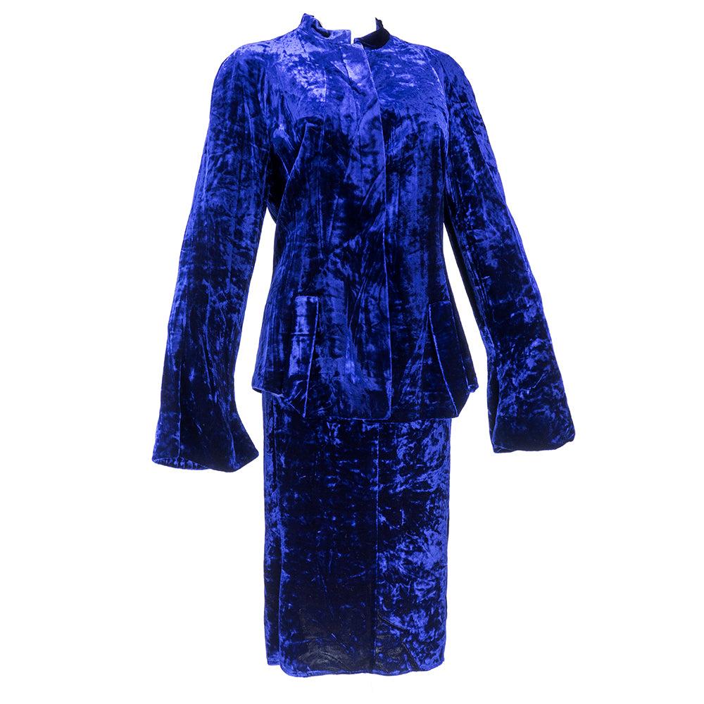 Ensemble in silk rayon blend velvet. In midnight blue (picture appear purple - in reality  a deep blue).  Consisting of nehru-style collar jacket with bell sleeves, hidden buttons and slash pockets. Fully lined. Mid-length matching skirt is unlined.