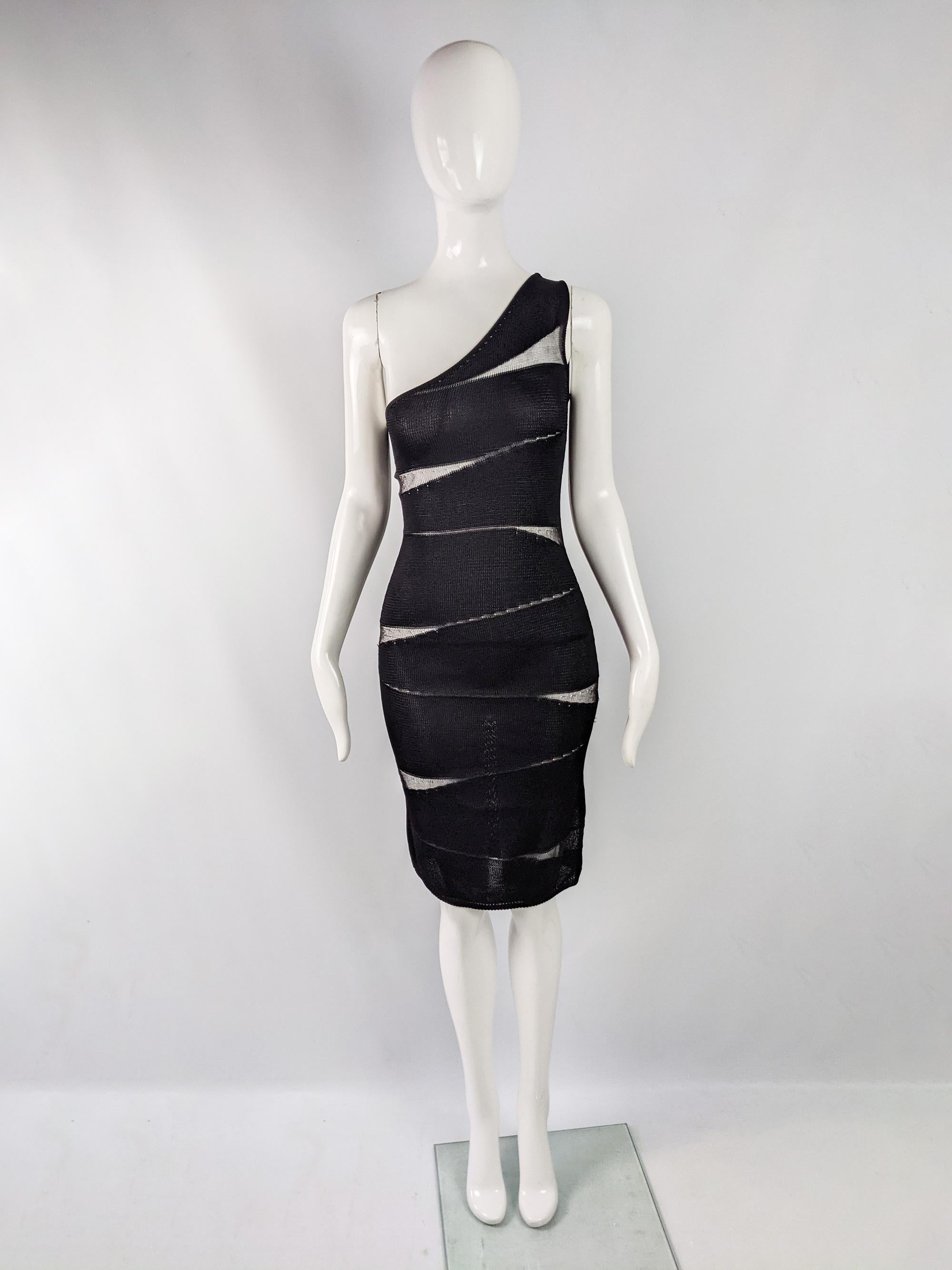 A stunning vintage knit dress from the 80s by luxury Italian fashion house, Krizia. In a black rayon and silk knit fabric with a slashed body conscious design, that is thicker in places and thinner so that the dress is sheer, creating a sexy look,