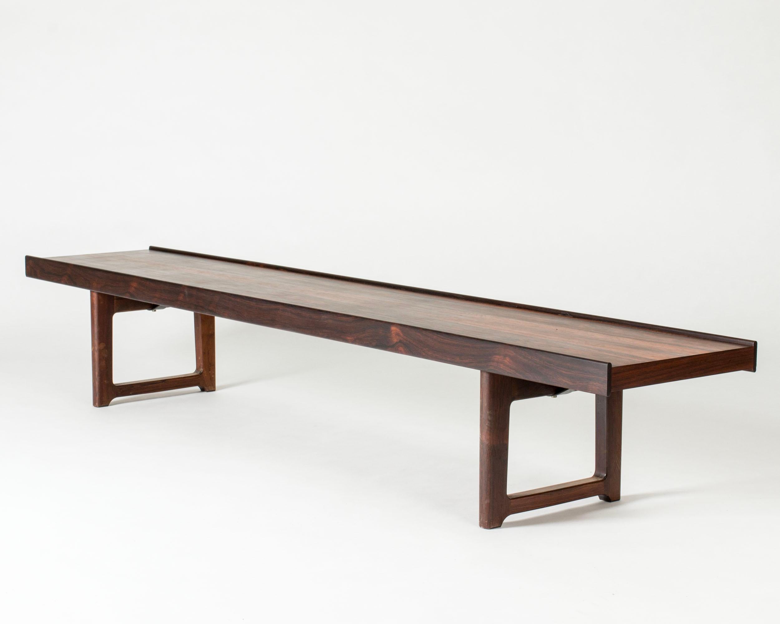 Sleek rosewood “Krobo” bench by Torbjørn Afdal, with beautiful, striking veneer. Great as a coffee table or room divider.