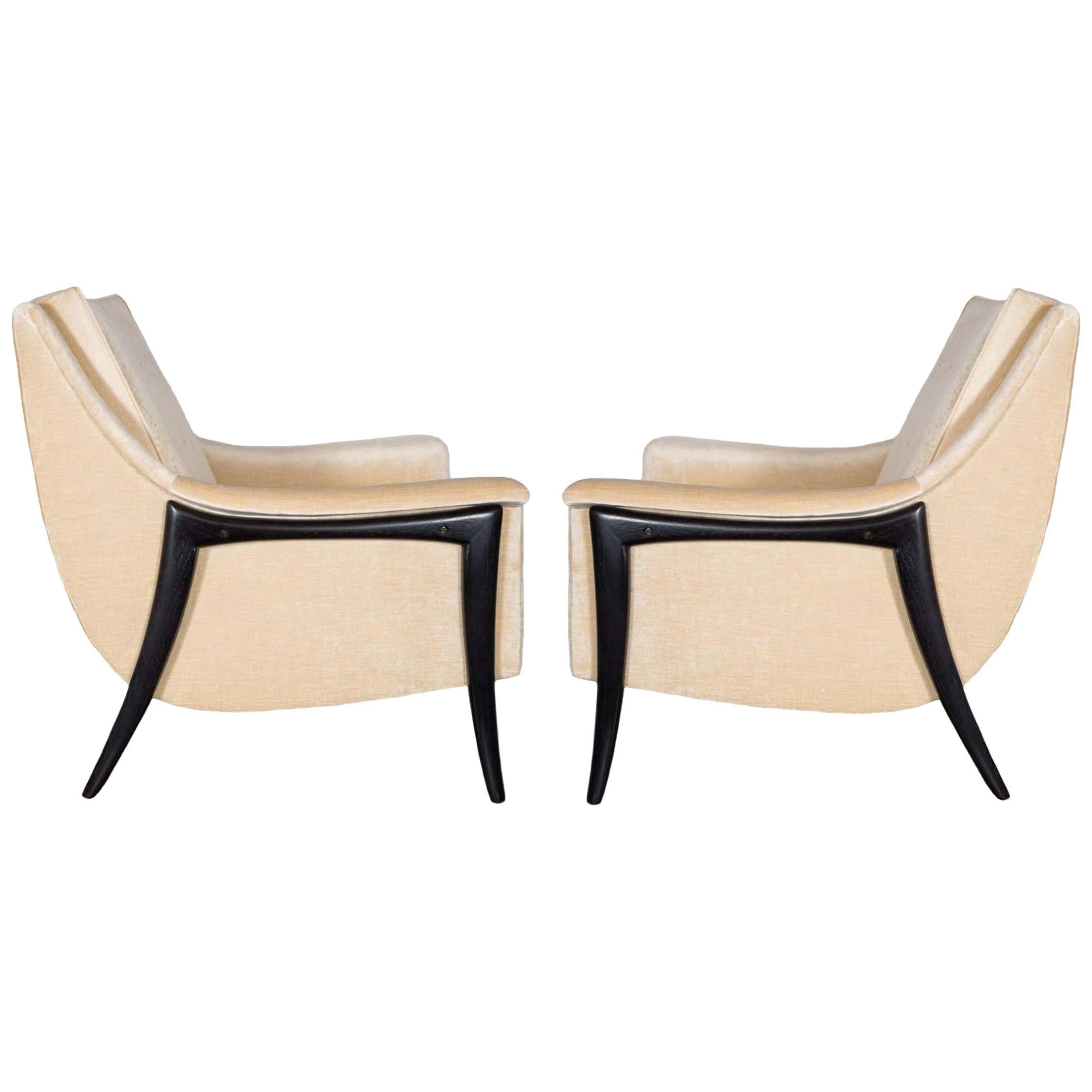 This stunning pair by Kroehler Avant Designs. Featuring sleek curved backs, leading to padded arms with a removable seat cushions all rising on sculptural form splayed legs. The legs are made of walnut and have a nice ebonized finish that
