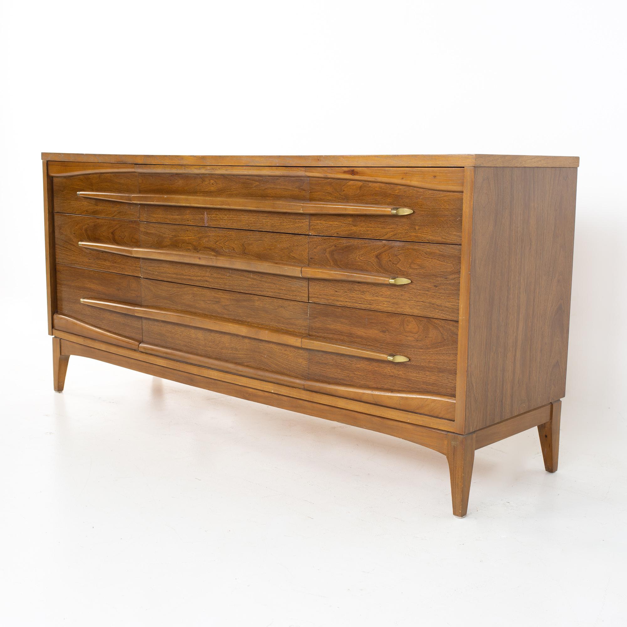 Kroehler Furniture mid century walnut and brass 9 drawer lowboy dresser
Dresser measures: 64.25 wide x 18.25 deep x 31.25 inches high 

All pieces of furniture can be had in what we call restored vintage condition. That means the piece is