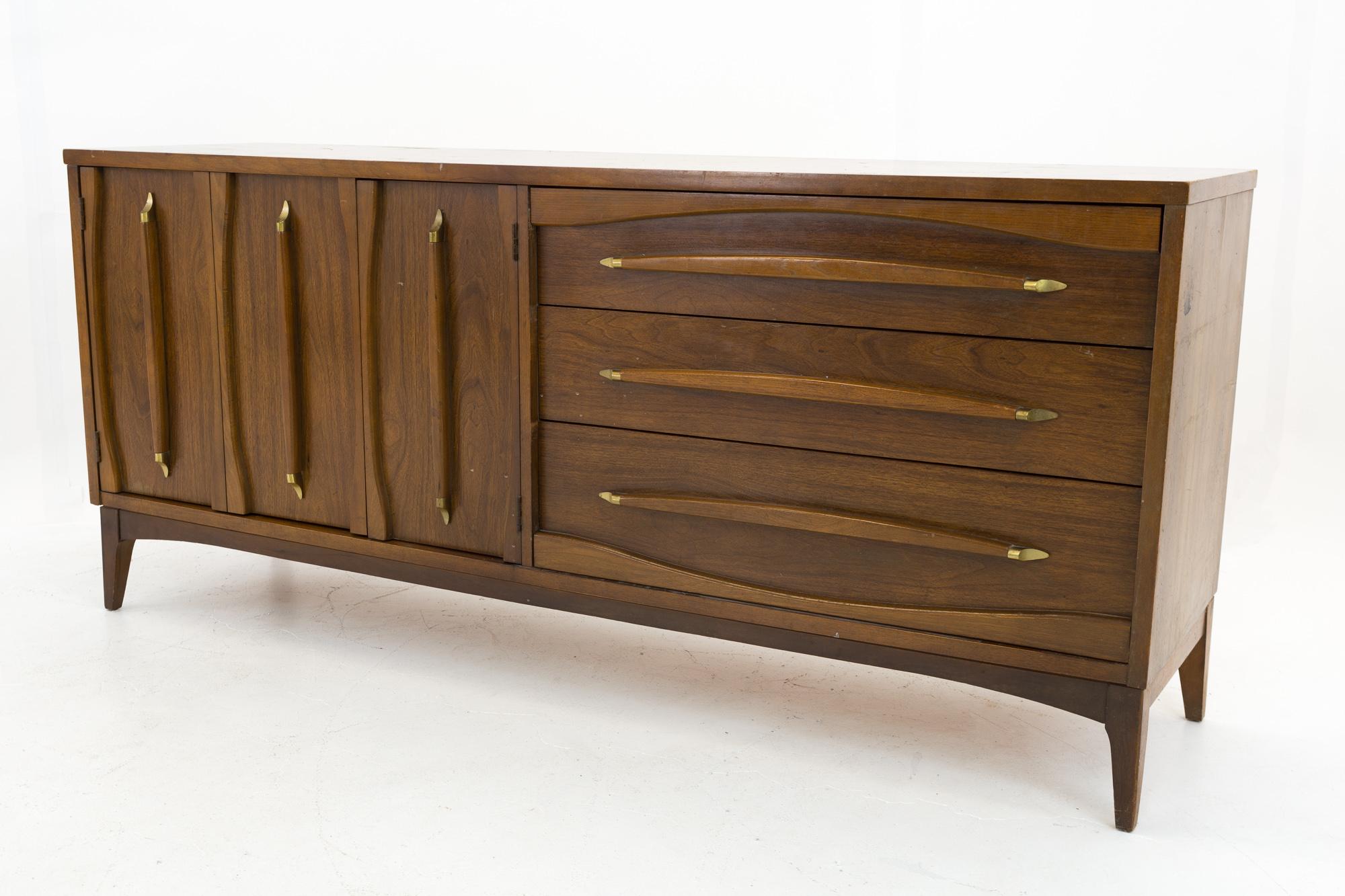 Kroehler walnut and brass mid century lowboy dresser with mirror
Dresser and mirror are: 70 wide x 18 deep x 31 inches high

All pieces of furniture can be had in what we call restored vintage condition. That means the piece is restored upon