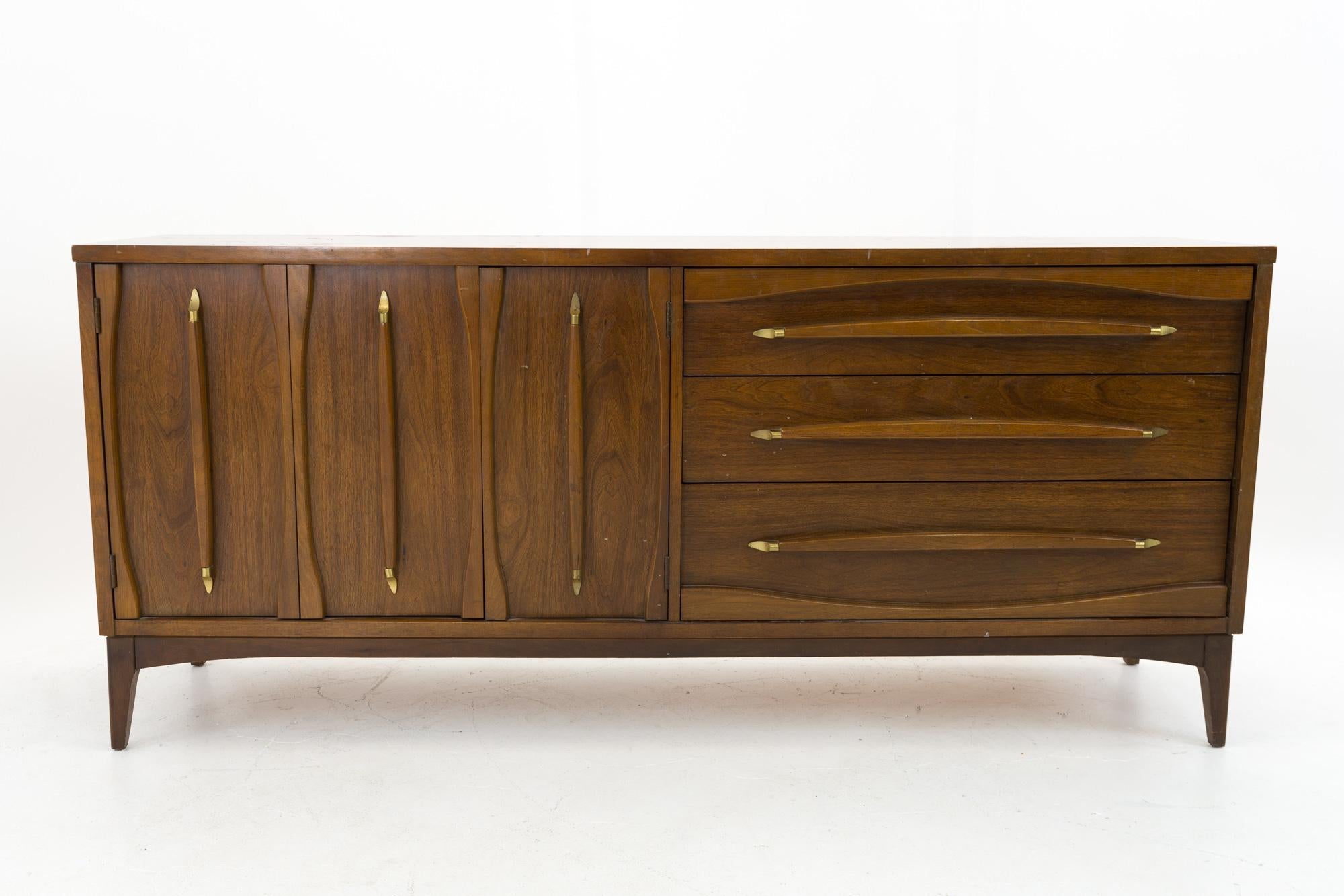 Kroehler Walnut and brass midcentury lowboy dresser with mirror

This dresser measures: 70 wide x 18 deep x 31 inches high

All pieces of furniture can be had in what we call restored vintage condition. That means the piece is restored upon