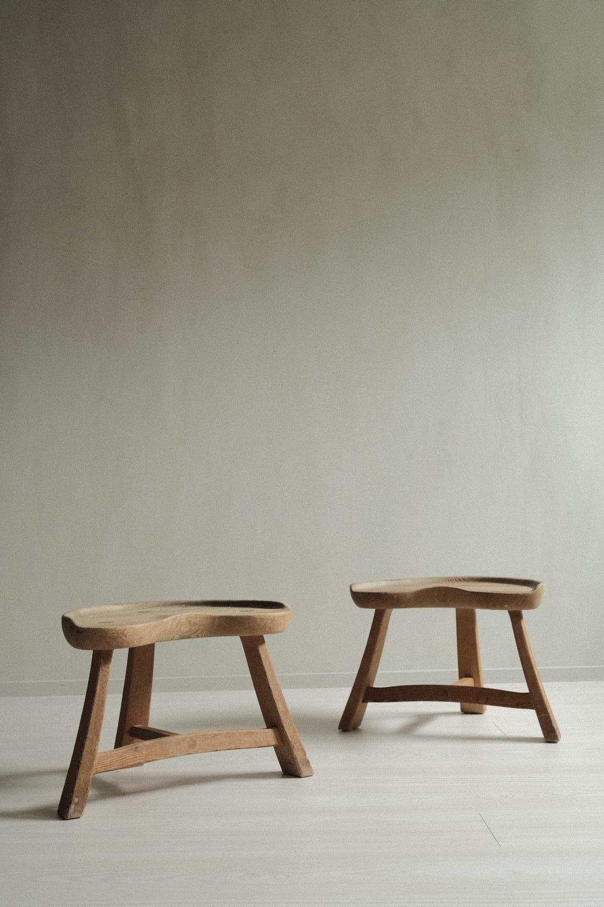 A set of two beautiful three legged pine stools, model no. 522 by Krogenæs Møbler. Designed in Norway in 1964 by the factory owner himself; Rangvald Krogenæs. This milking stool was called 