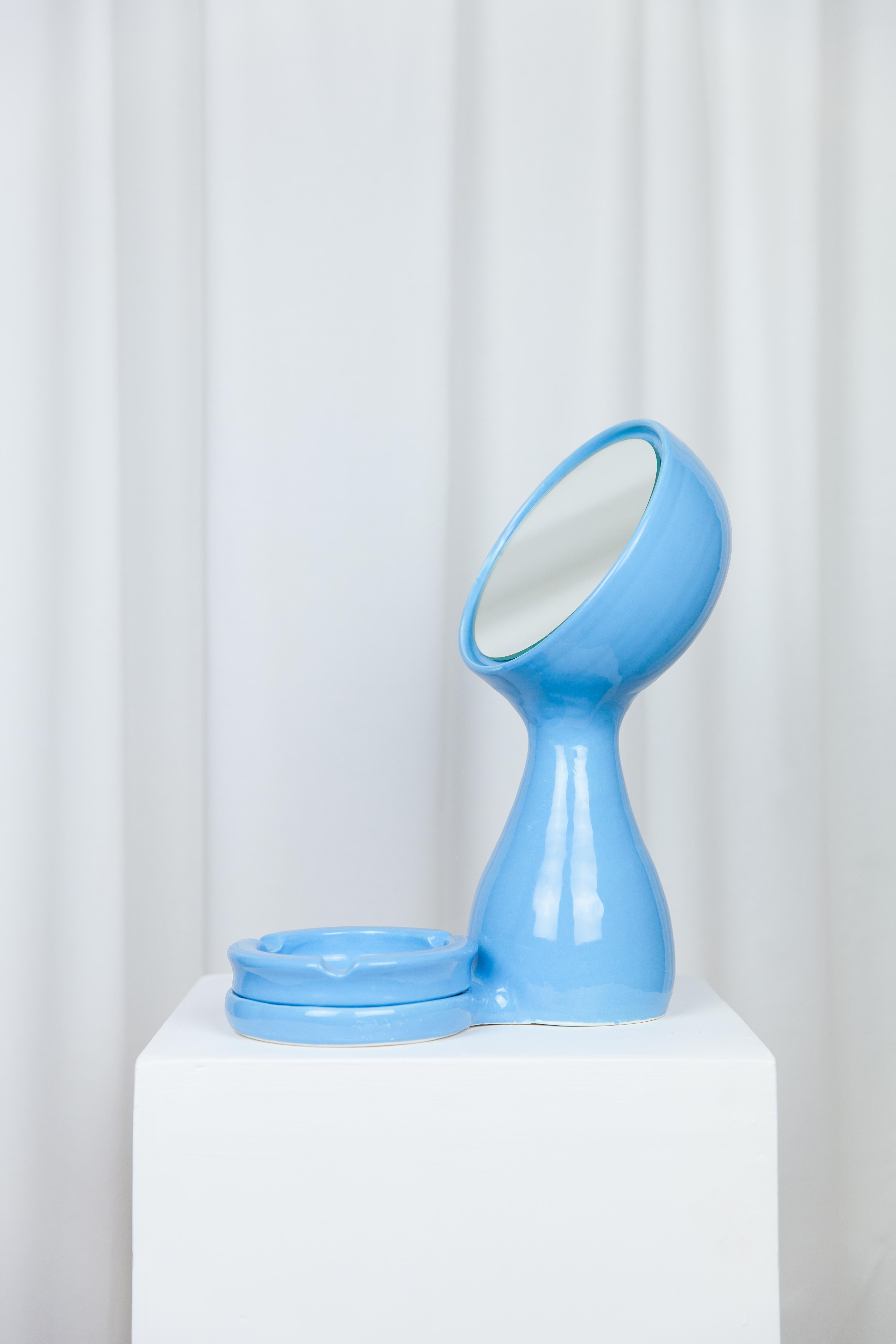 Kroli mirror + ashtray by Lola Mayeras
Dimensions: D 25 x W 16 x W 36 cm
Materials: Earthenware, mirror

Mirror with detachable ashtray in white earthenware, glazed blue.
This piece is designed and handcrafted in the south of France.

Lola