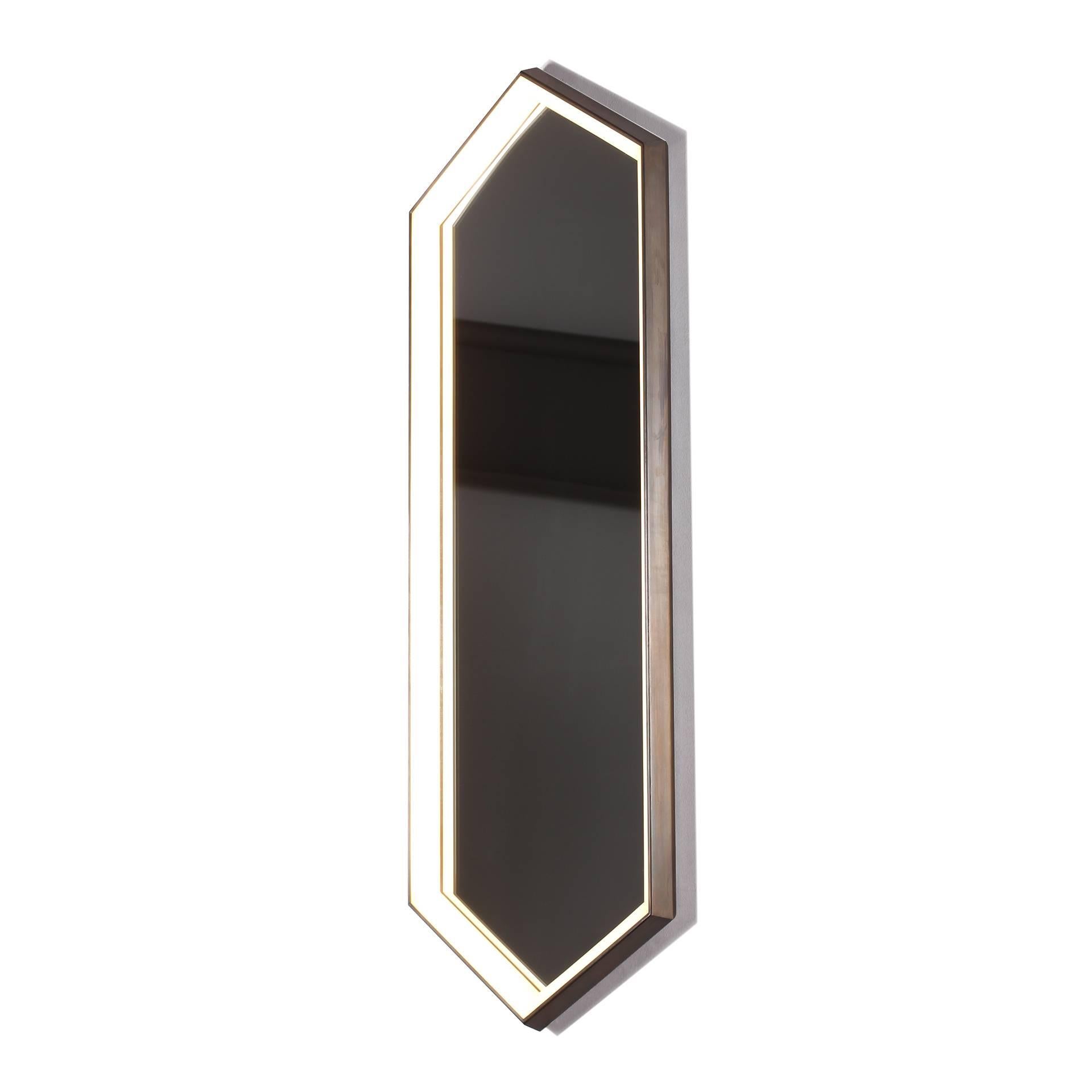 KRUOS Mirror beautifully combines a sconce and mirror into one piece, placing light where it is most needed. The edge-lit hexagonal form completely illuminates from all sides, avoiding unwanted shadowing. KRUOS Mirror is also available in a wider