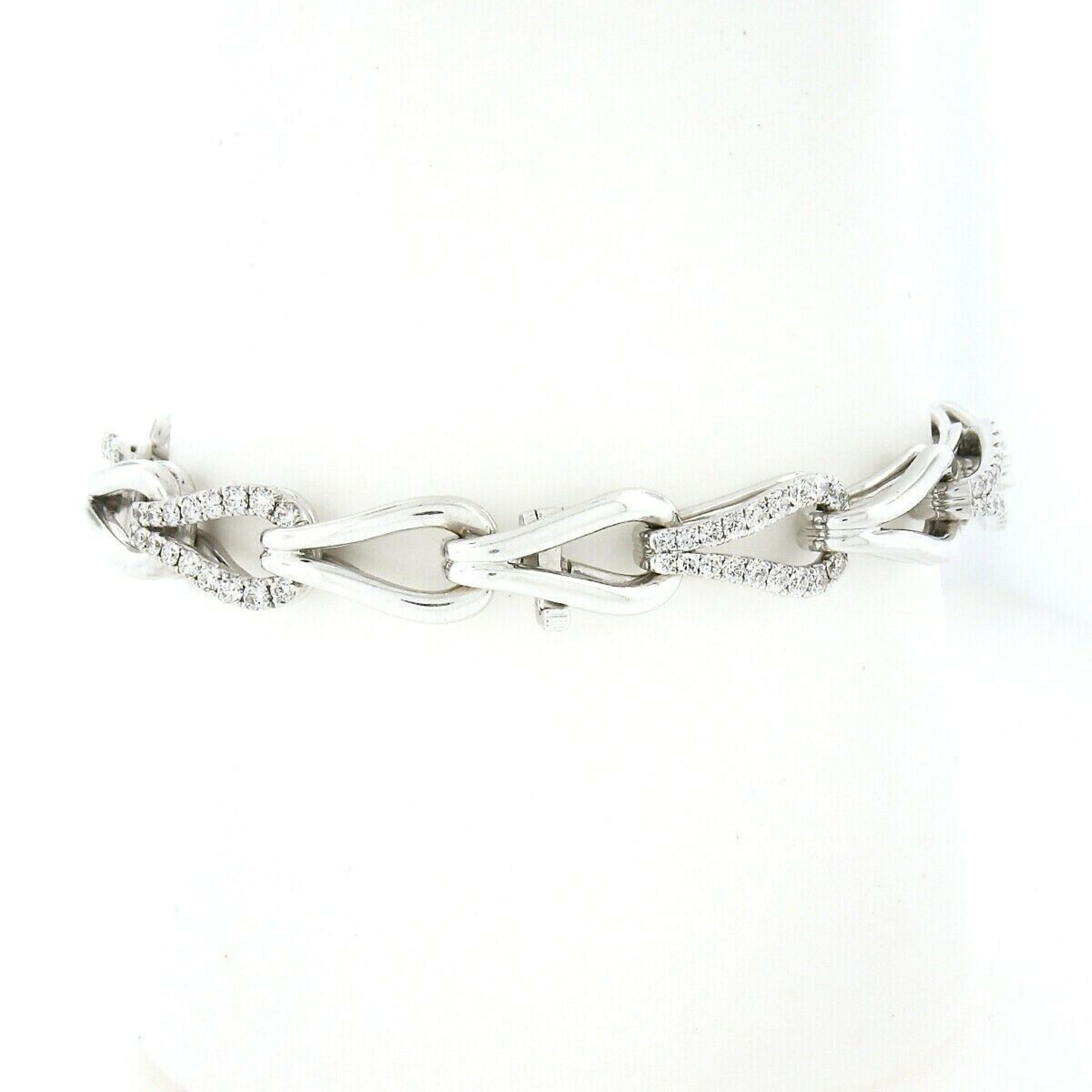 Here we have an absolutely gorgeous diamond bracelet designed by Charles Krypell that is crafted in solid 18k white gold. The bracelet is very well structured and features hook links that alternate with nice high-polished finish links and fine