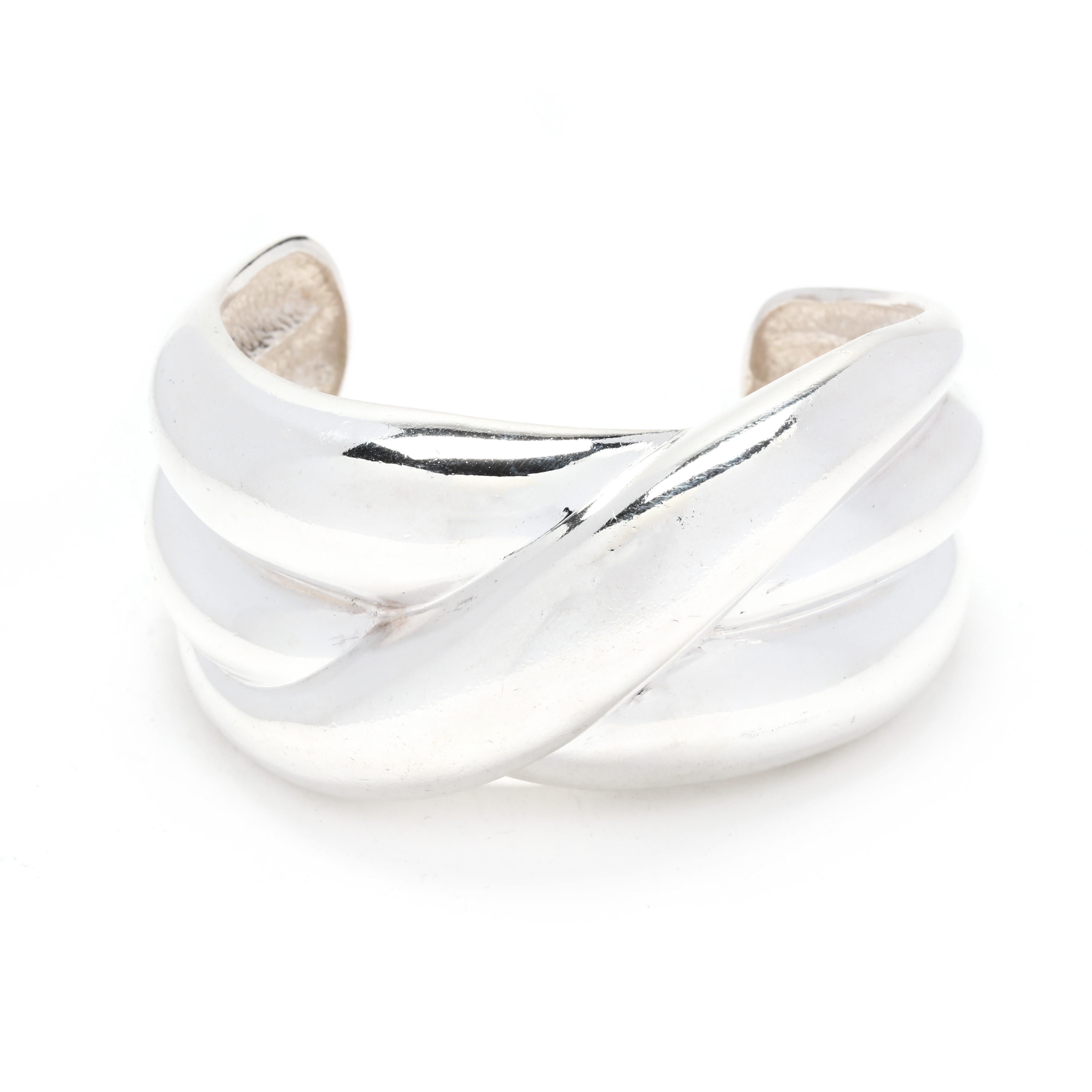 A vintage sterling silver bold crossover cuff bracelet design by Krypell. This bracelet features a design with three bands with central band crossing over.  It is stamped SS Krypell. 

Length: 6 inches with a 1.25 inch opening (slightly