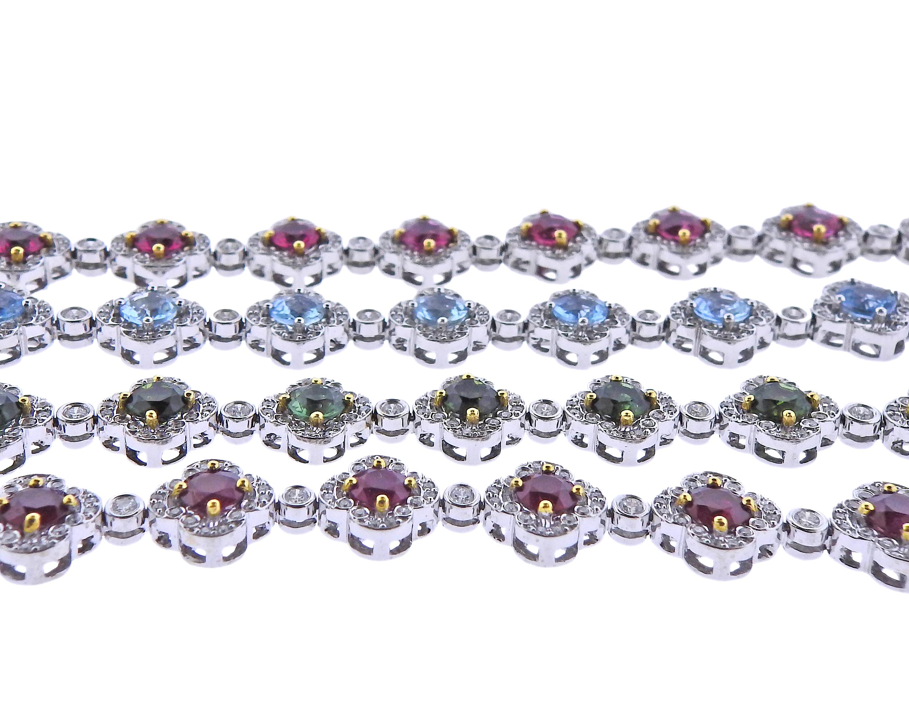 Set of 4 18k white gold bracelets by Charles Krypell, set with aquamarines, green tourmalines, rubies and a total of approx. 5.80ctw in diamonds. Bracelets are 7.25