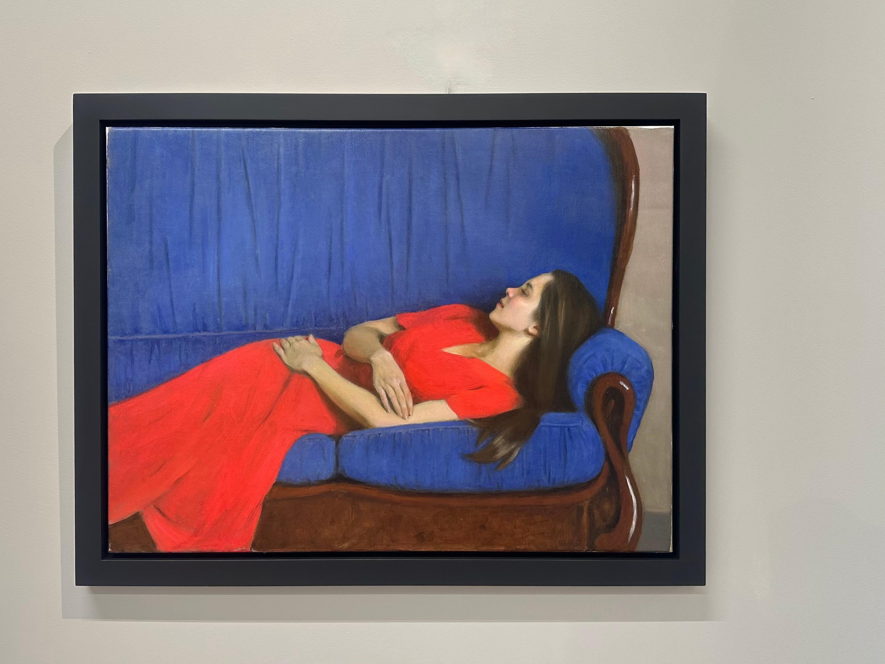 Midday nap- 21st century painting of a girl in a red dress on a blue sofa - Painting by Ksenya Istomina