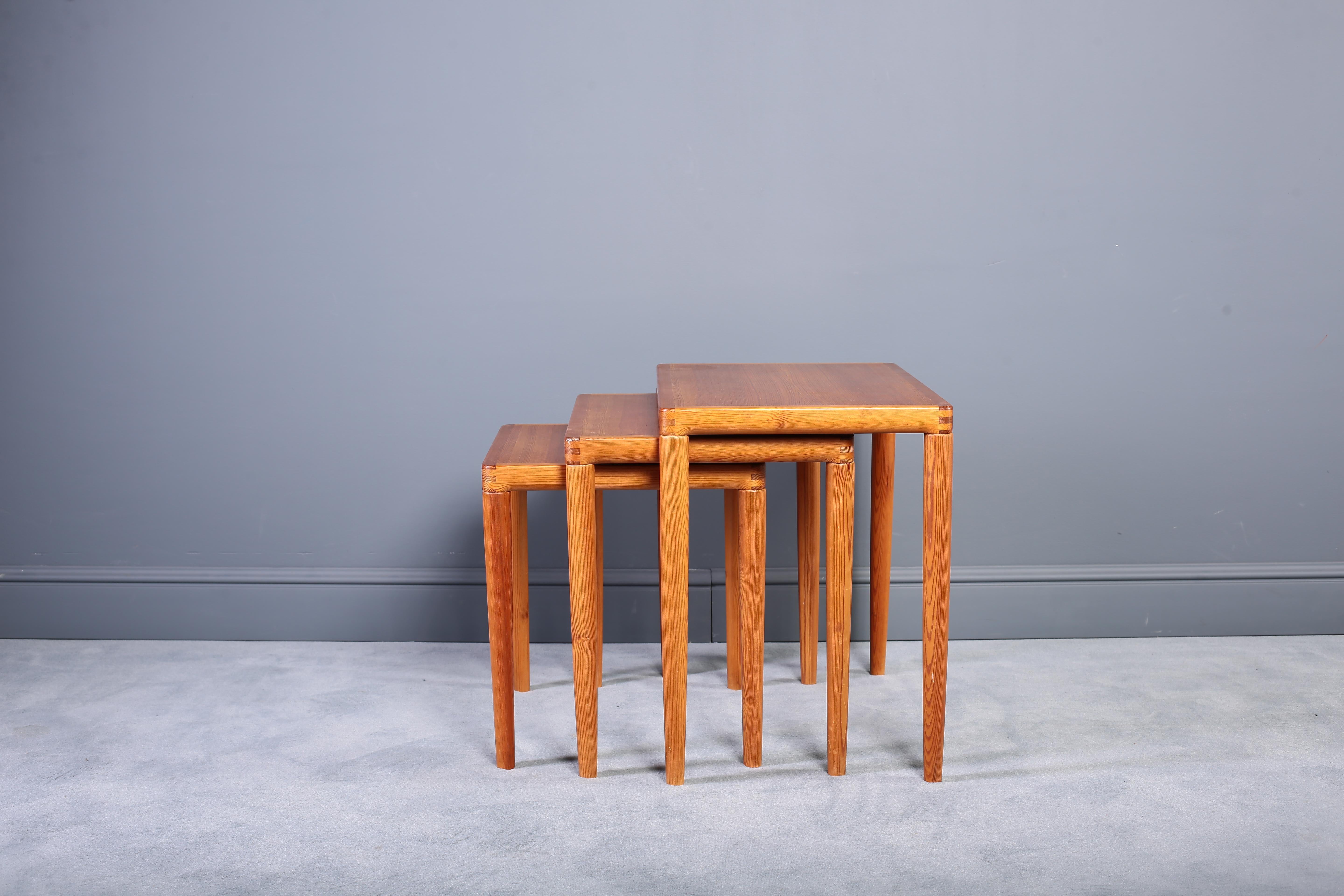 Set of three Mid-Century Modern Danish teak nesting tables of ascending size. Fine construction is evident in the elegantly turned corners, seamless finger joinery and grace in design. These tables are exceptional. Our team of professionals have