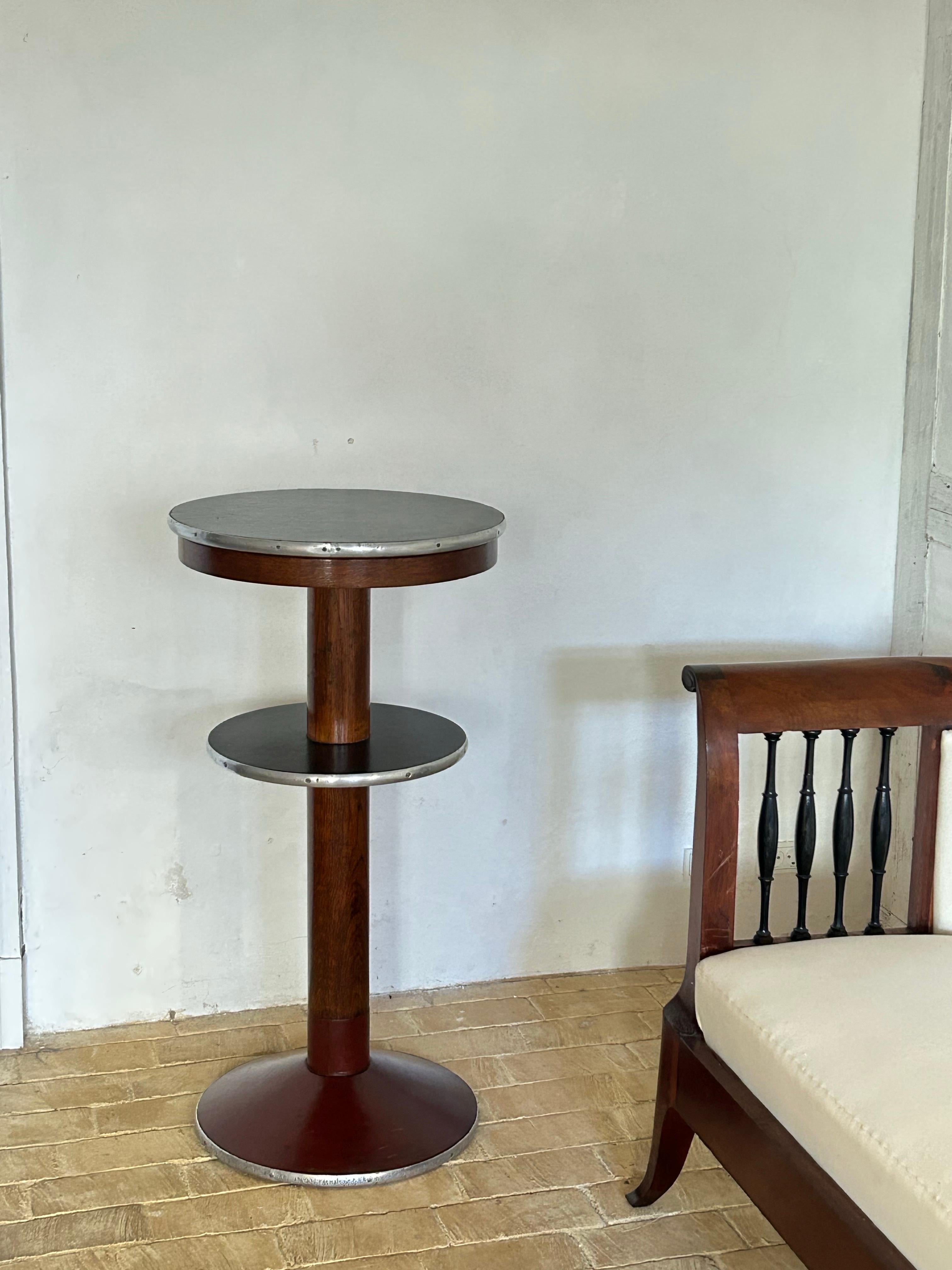 Circular table, 1934
Oak, steel, red lacquered linoleum base
Height 100 cm

Designed in 1934 by DSB’s chief architect Knud Tanggaard Seest for use in the waiting rooms of Danish railway stations. The table exemplifies Seest’s restrained