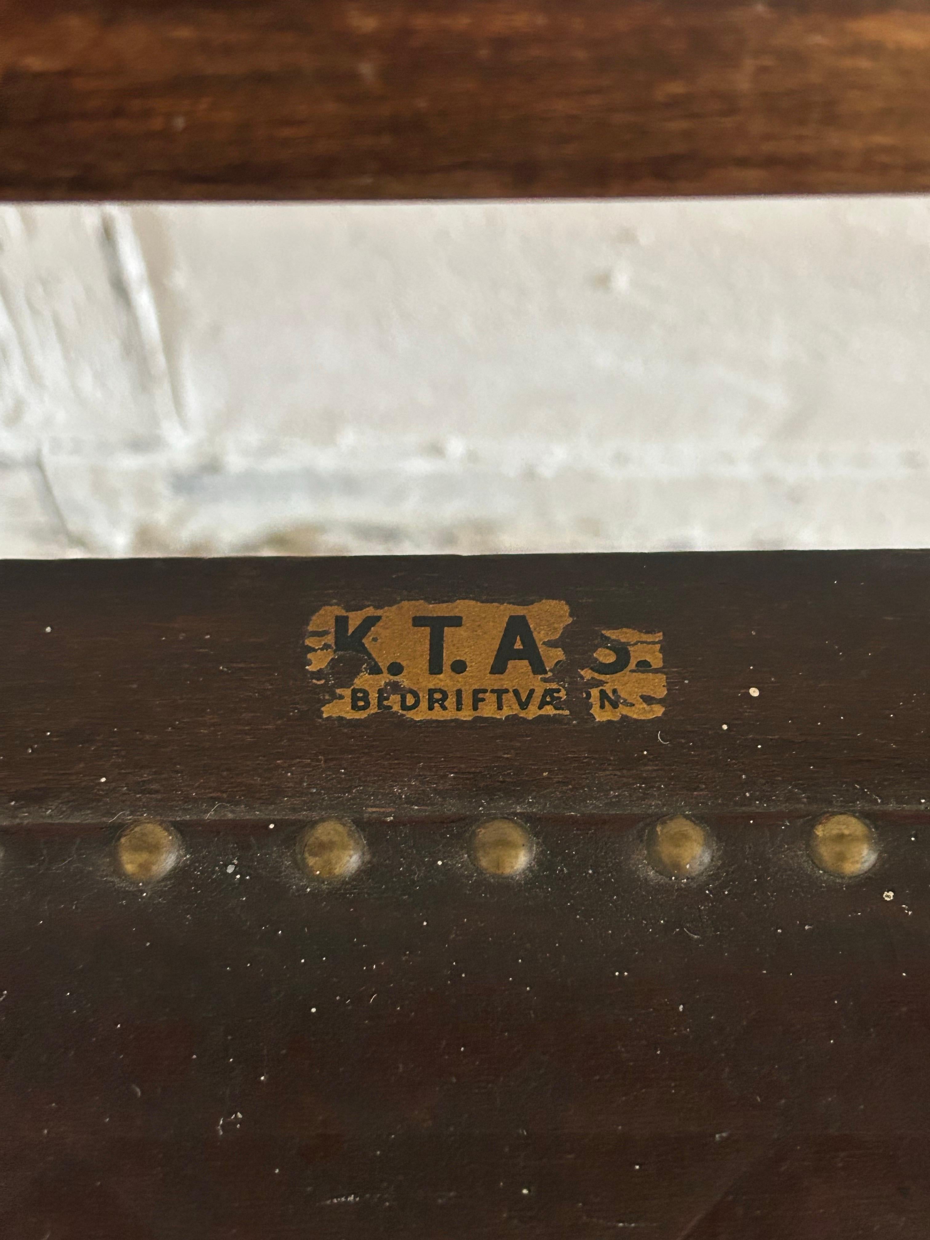 Chair designed in 1935 by Jens Ingwersen and Jørgen V. Jepsen for K.T.A.S. (Kjøbenhavns Telefon Aktieselskab), the Copenhagen Telephone Company.

Executed in stained beech with original leather upholstery, the chair embodies the functional yet
