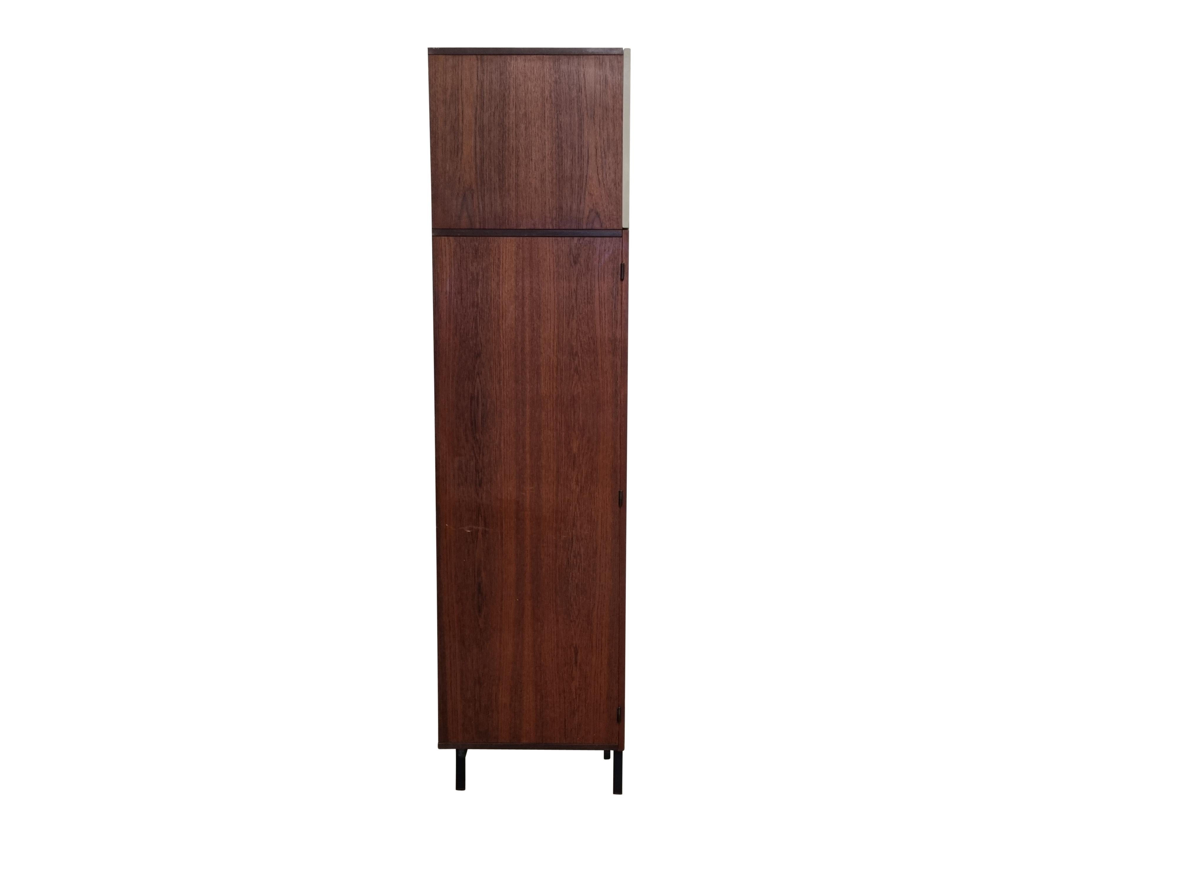Mid century teak wardrobe designed by Cees Braakman for the Japanese series in 1958 and produced by Pastoe.

The cabinet features 2 doors which can open in two parts, one door has a mirror.

Shelves, coat hanger and two top storage parts with