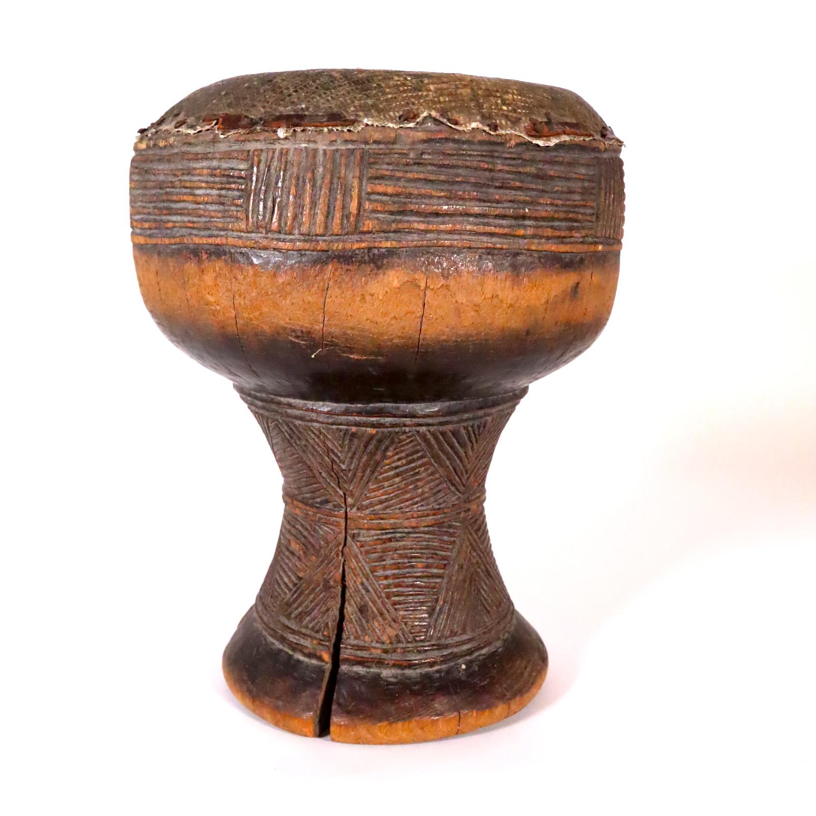 A fine old drum from the Kuba kingdom, possibly Lele or Kuba People, Democratic Republic of Congo, Central Africa. Probably created in the early to middle part of the 20th century. Wood with reptile skin drum head. The hourglass shape with nicely