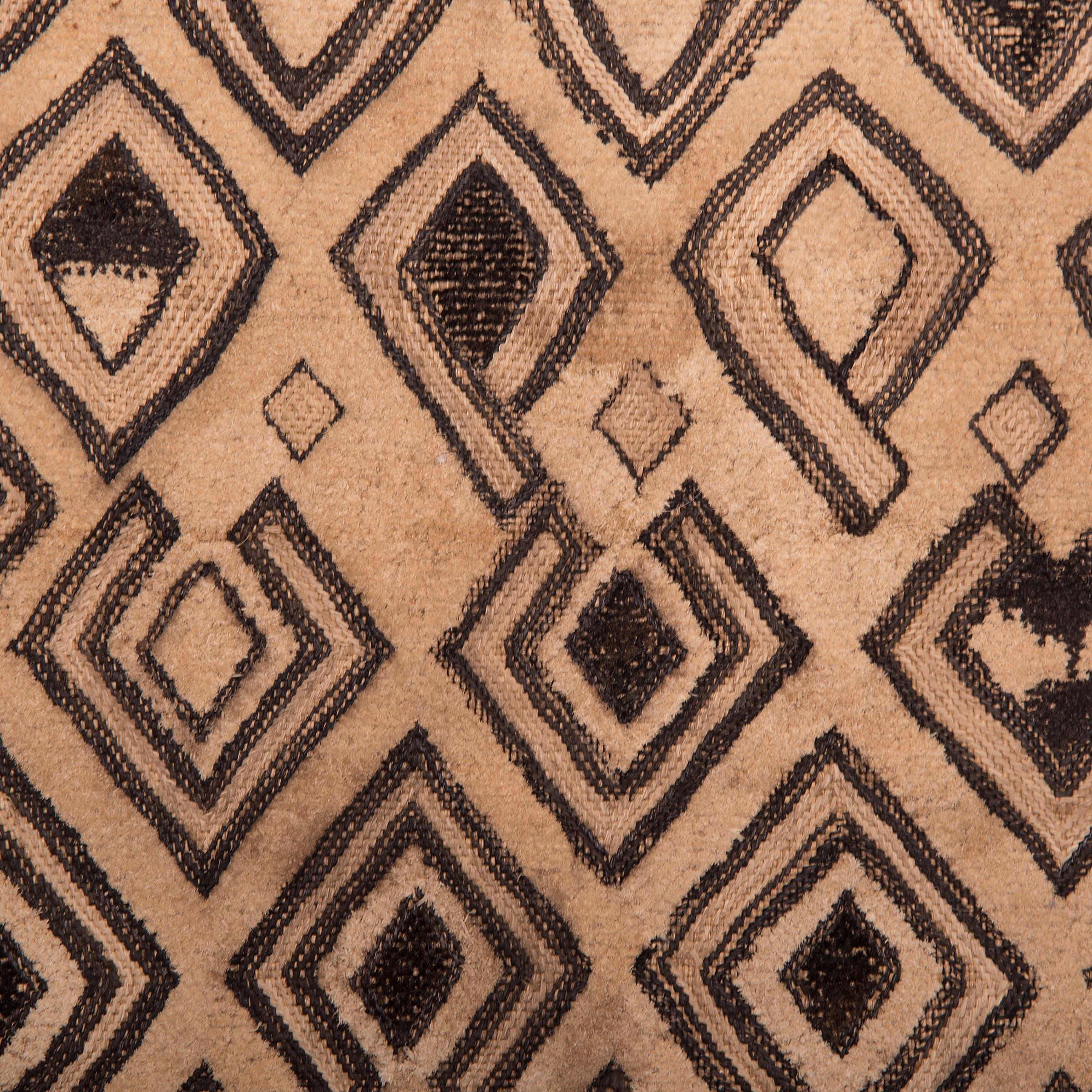 Visually dynamic and highly textured, this raffia panel expresses the irregular, geometric patterns typical of Kuba textile art. Created by an artisan of the Kuba People of the Democratic Republic of the Congo, this form of woven textile is made by