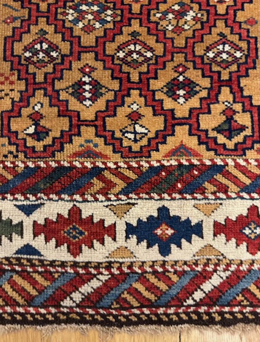 Kuba rug from eastern Caucasus,Kuba district

Age: dated 1298=1881

Size: 4′.1″x3′.2″ (124×97 cm)

The honey field displays a stepped offset five column red lattice enclosing beautifully colored lozenges.Along the sides are combs,a