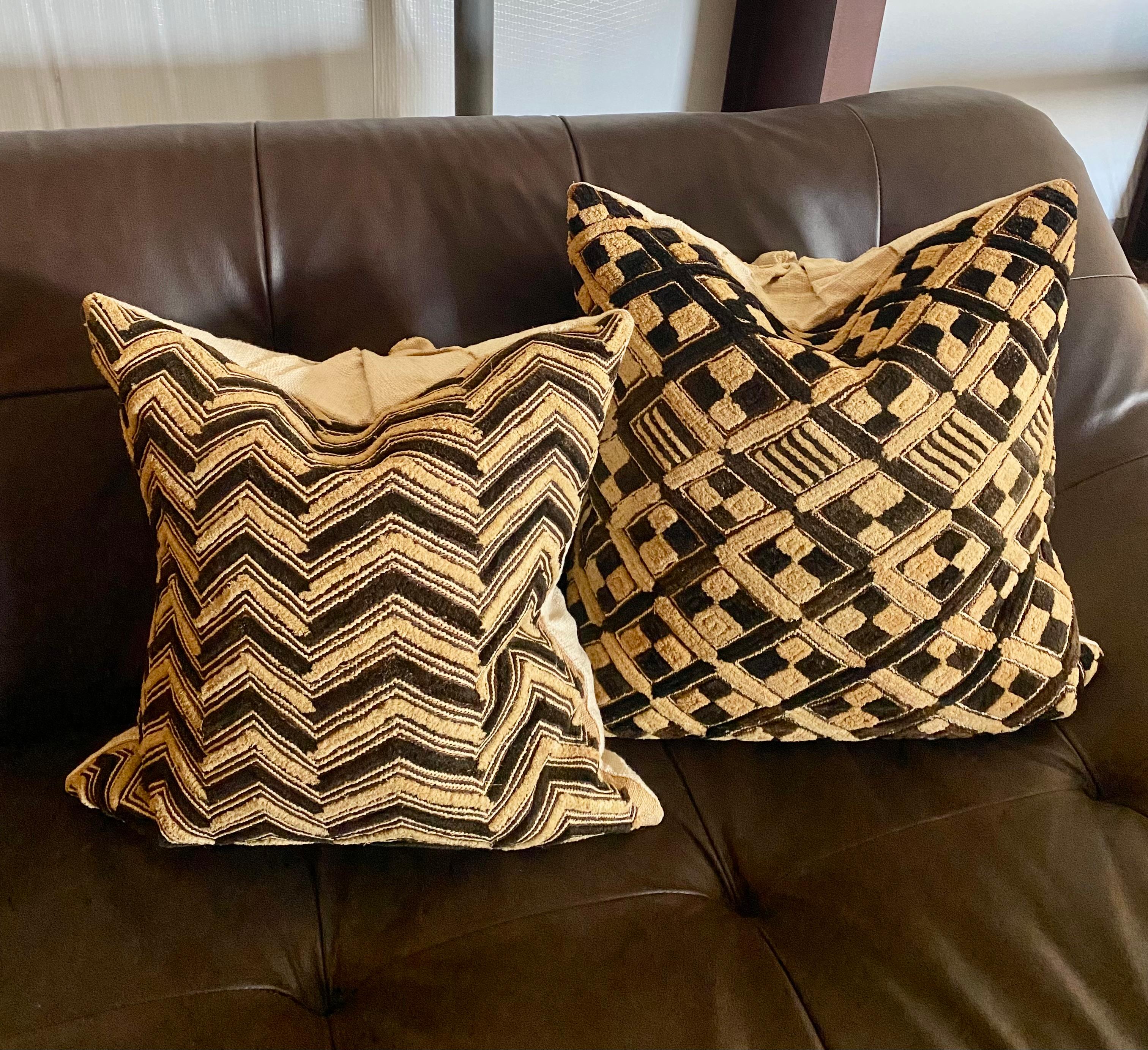 Kuba Shoowa pillows…crafted from a handwoven palm wood raffia from the Democratic Republic of Congo (formerly Zaire). Each one is unique; custom made in 2006 with raw silk backs. 

Sizes are as follows as displayed on sofa:

Far left: 17.5