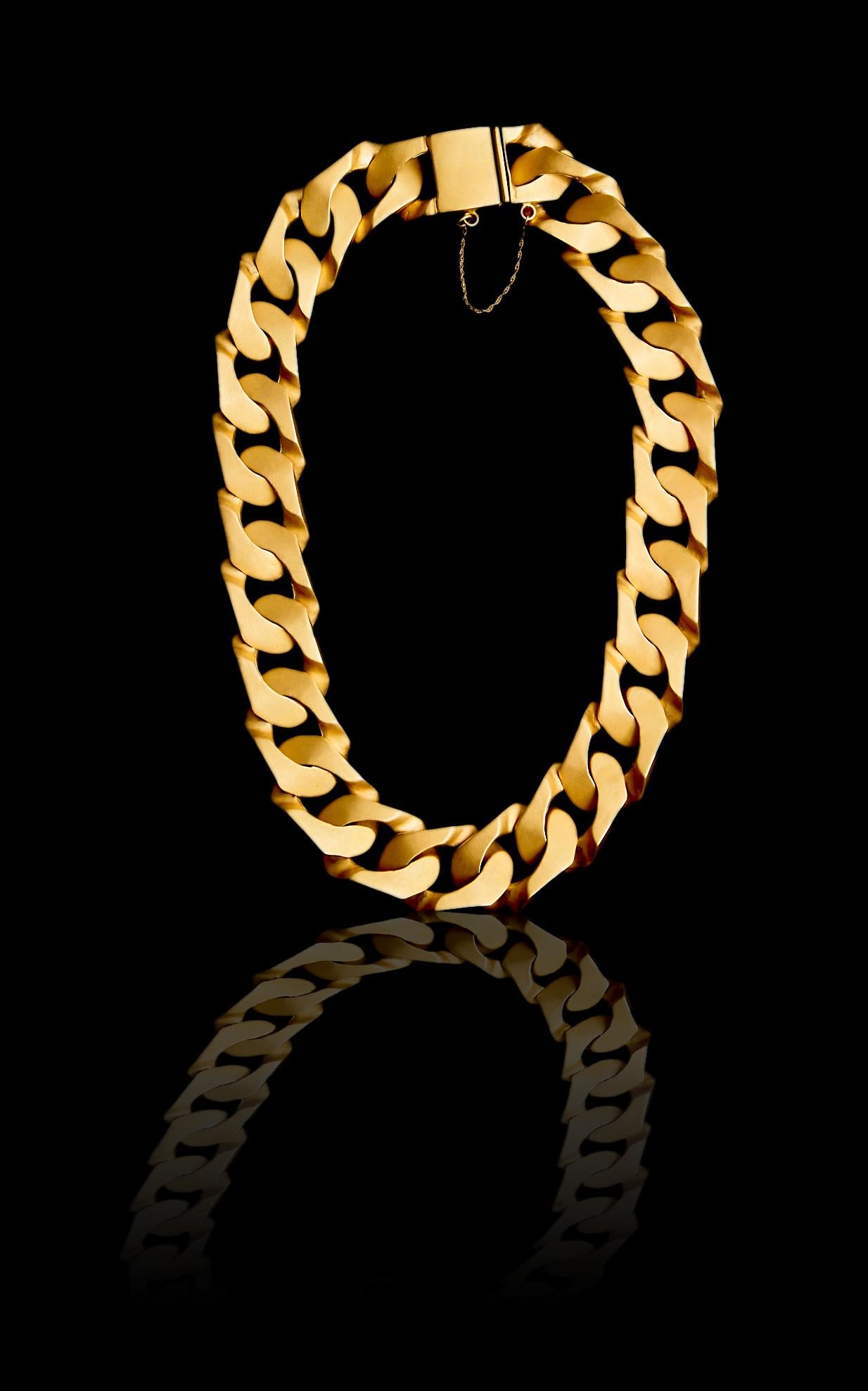 A sexy, substantial Cuban chain necklace to take you from day to night, all handmade. This iconic, statement, classic jewel has been made oversize and includes a safety chain so you will never lose it! Select your gold finish and the cuff that