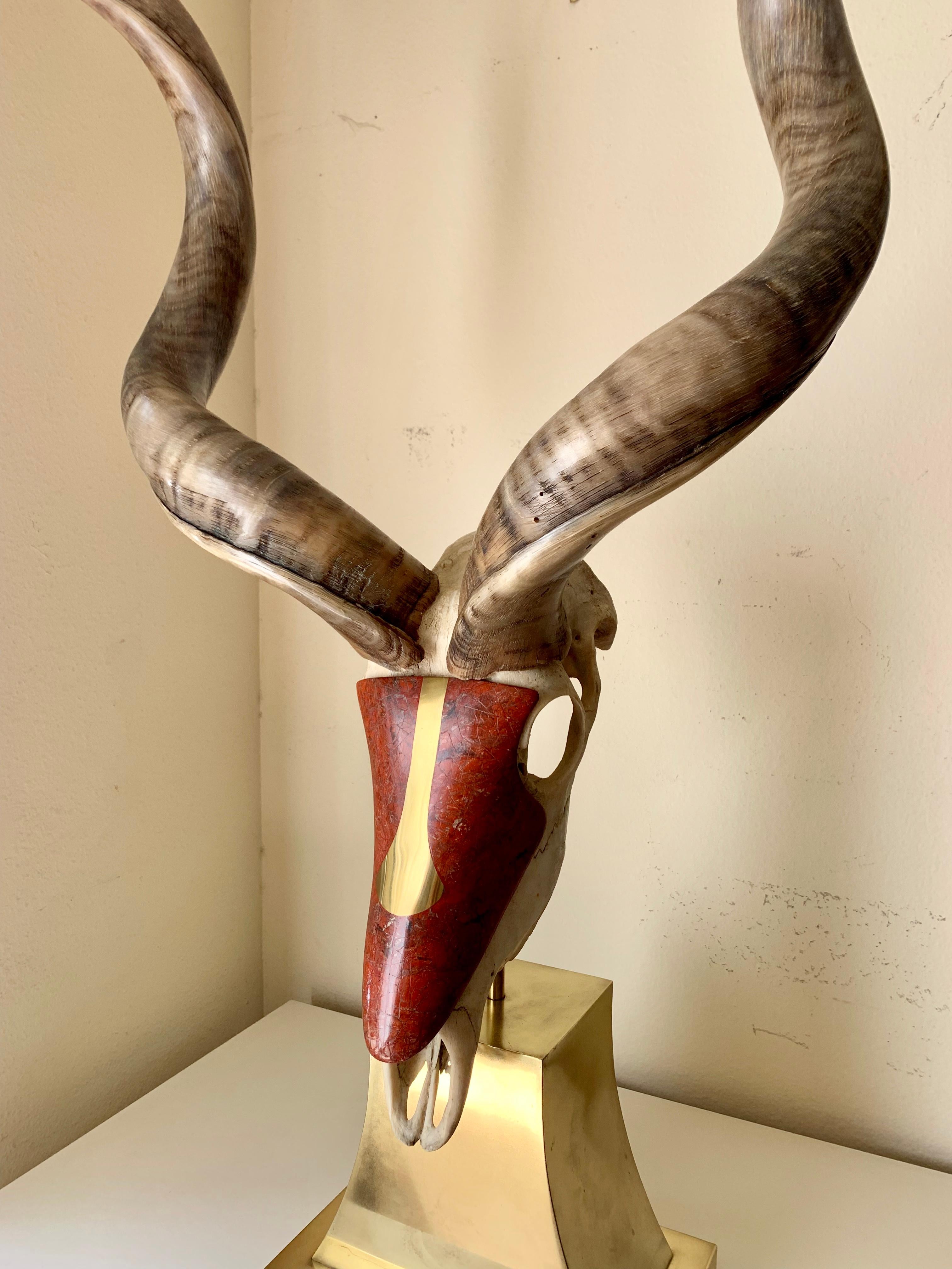 Kudu skull sculpture by Jonson & Marcius. Beautifully crafted with a red jasper detail and mounted on a brass stand.